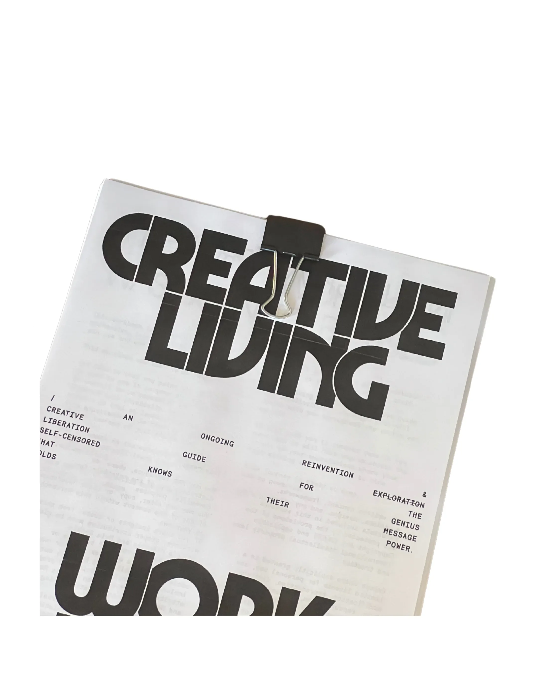 A printout of a magazine or poster with the words "CREATIVE LIVING" in large, bold letters. The page is clipped with a black binder clip.