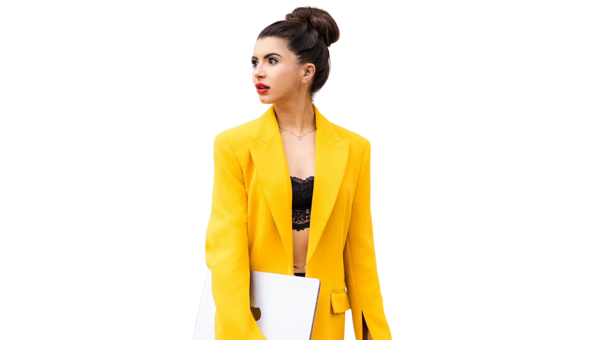 Young woman with dark hair styled in an updo, wearing a bright yellow blazer over a black lace top, holding a white folder with a heart cutout, against a dark background.