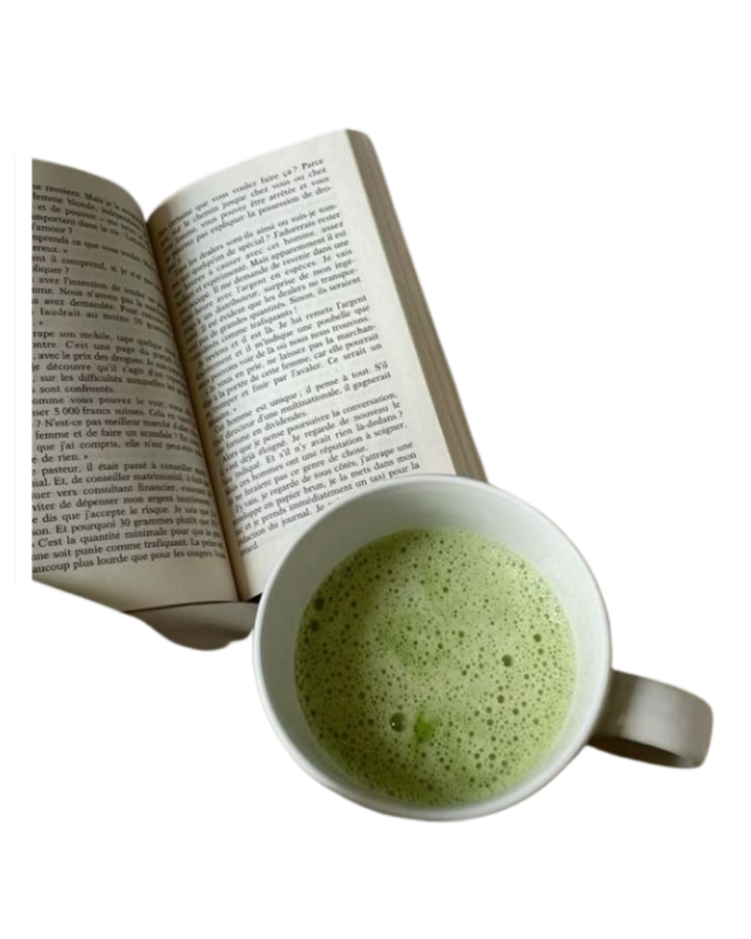 Open book and mug of green tea on a white surface
