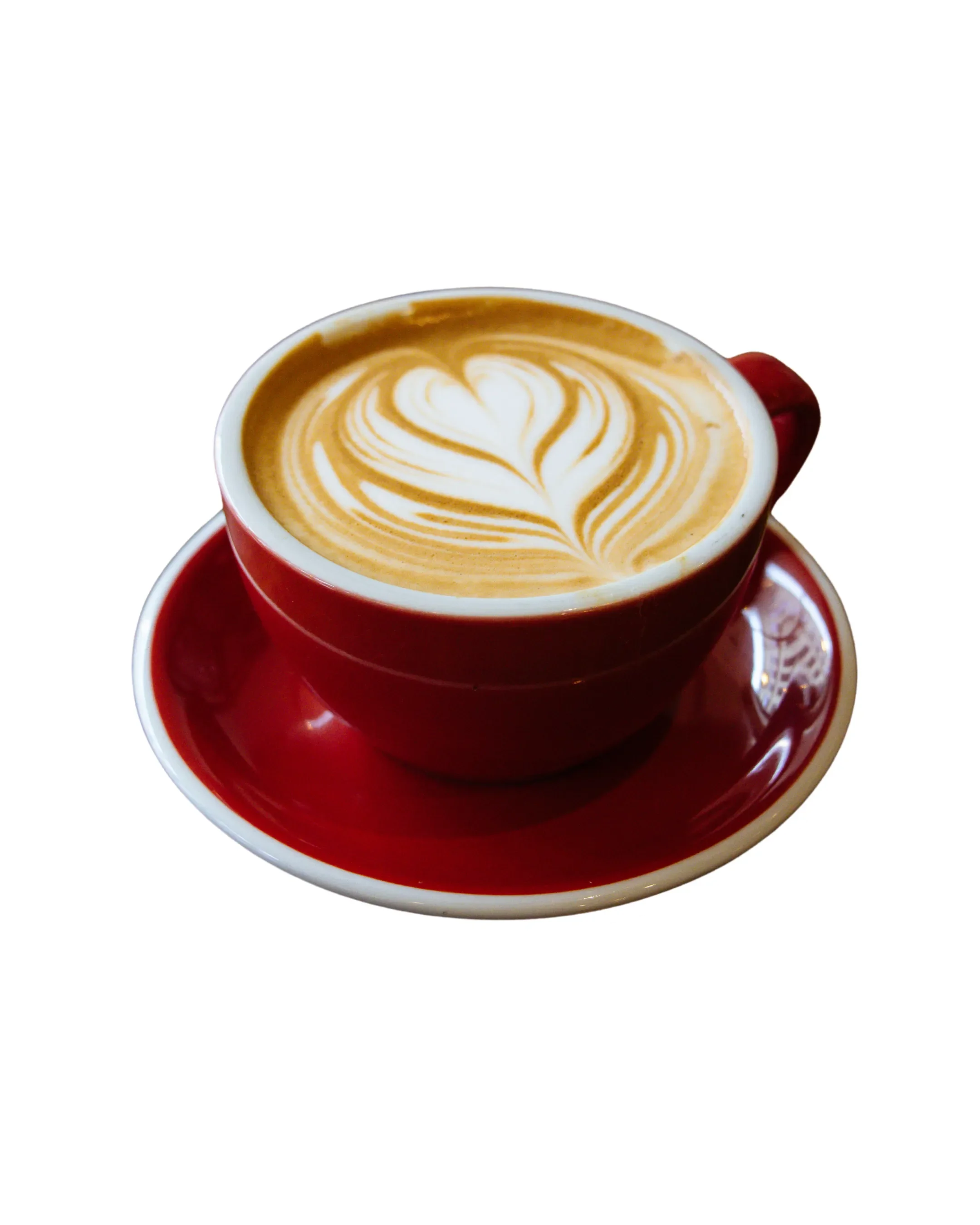 Red cup of latte with heart-shaped latte art on top, placed on a matching red saucer on a black background.