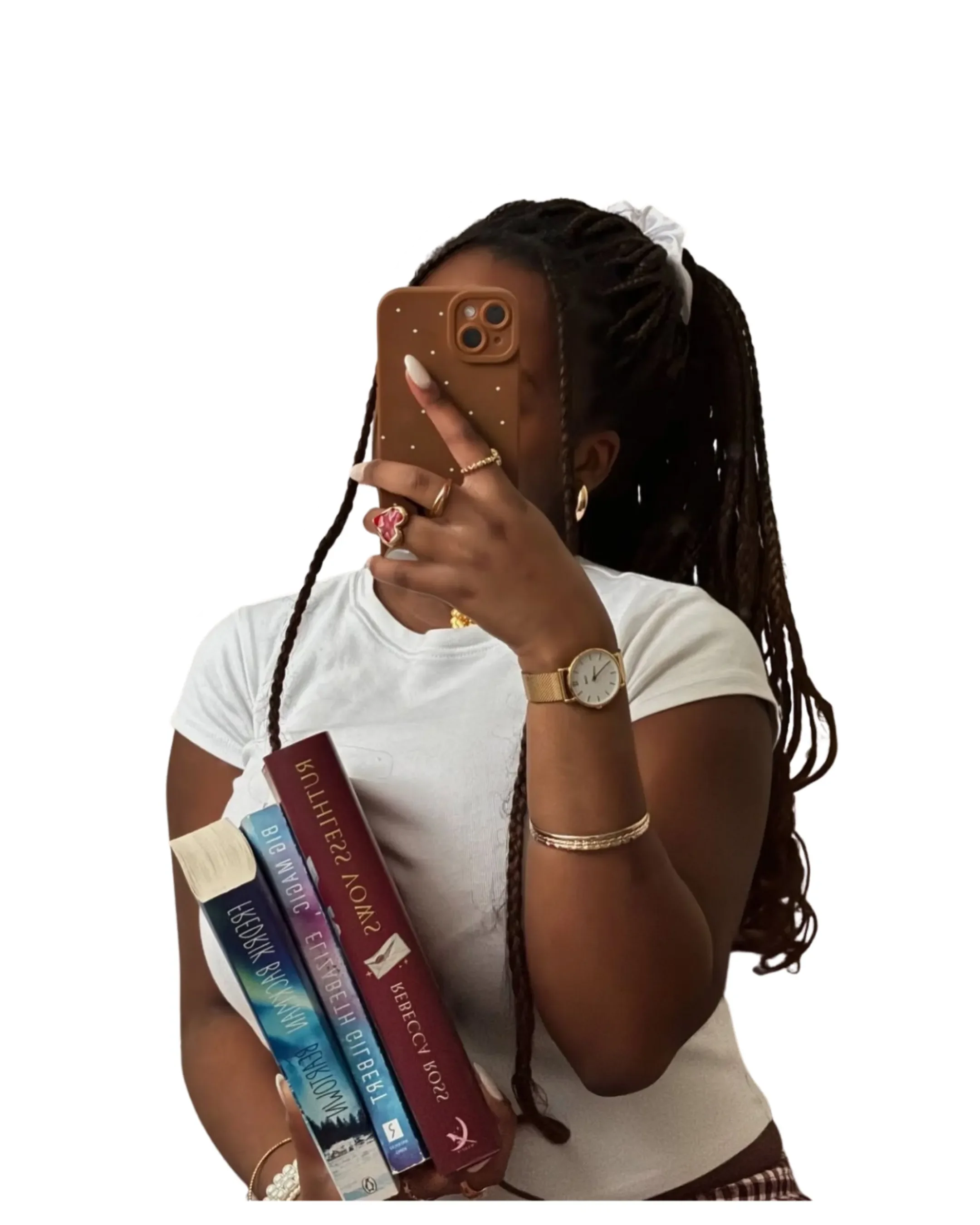 Person with long braided hair taking a mirror selfie with a smartphone, holding three books in one arm, wearing a white t-shirt, wristwatch, bracelets, and rings.