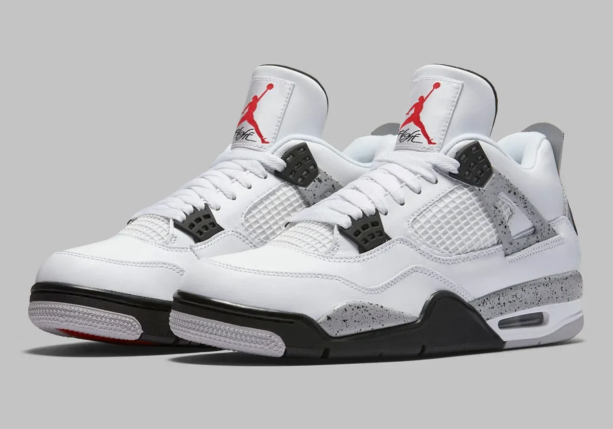 White Air Jordan sneakers with black accents and speckled gray detailing on a gray background.