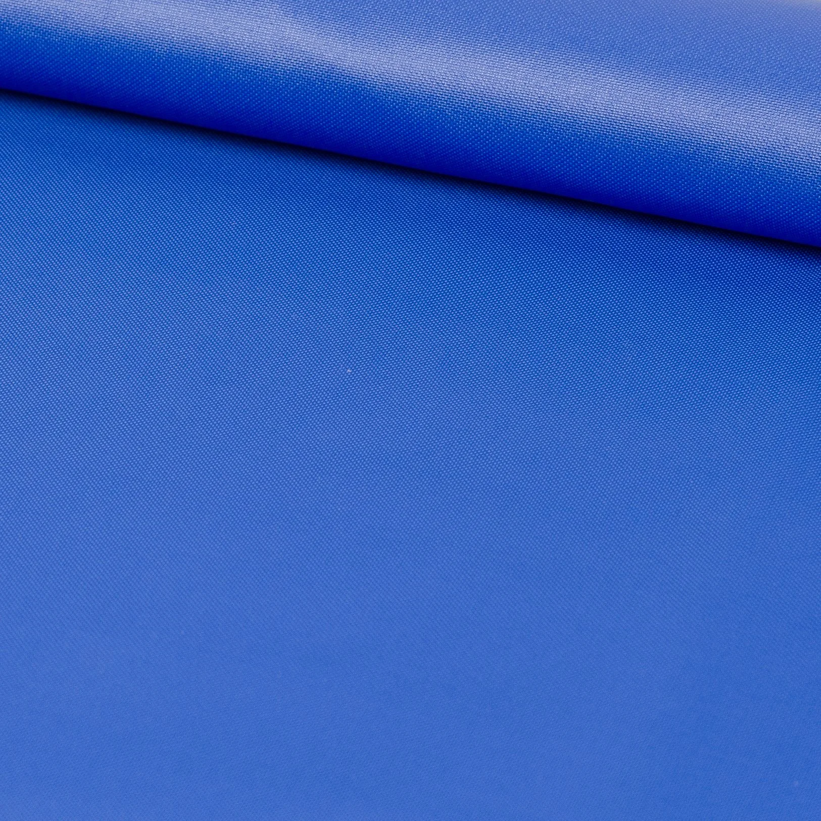 Close-up view of a folded piece of blue textile fabric with a textured surface.