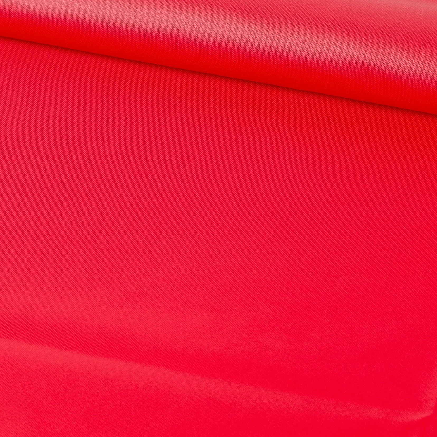 Close-up of bright red fabric with a textured surface and a visible fold or crease.