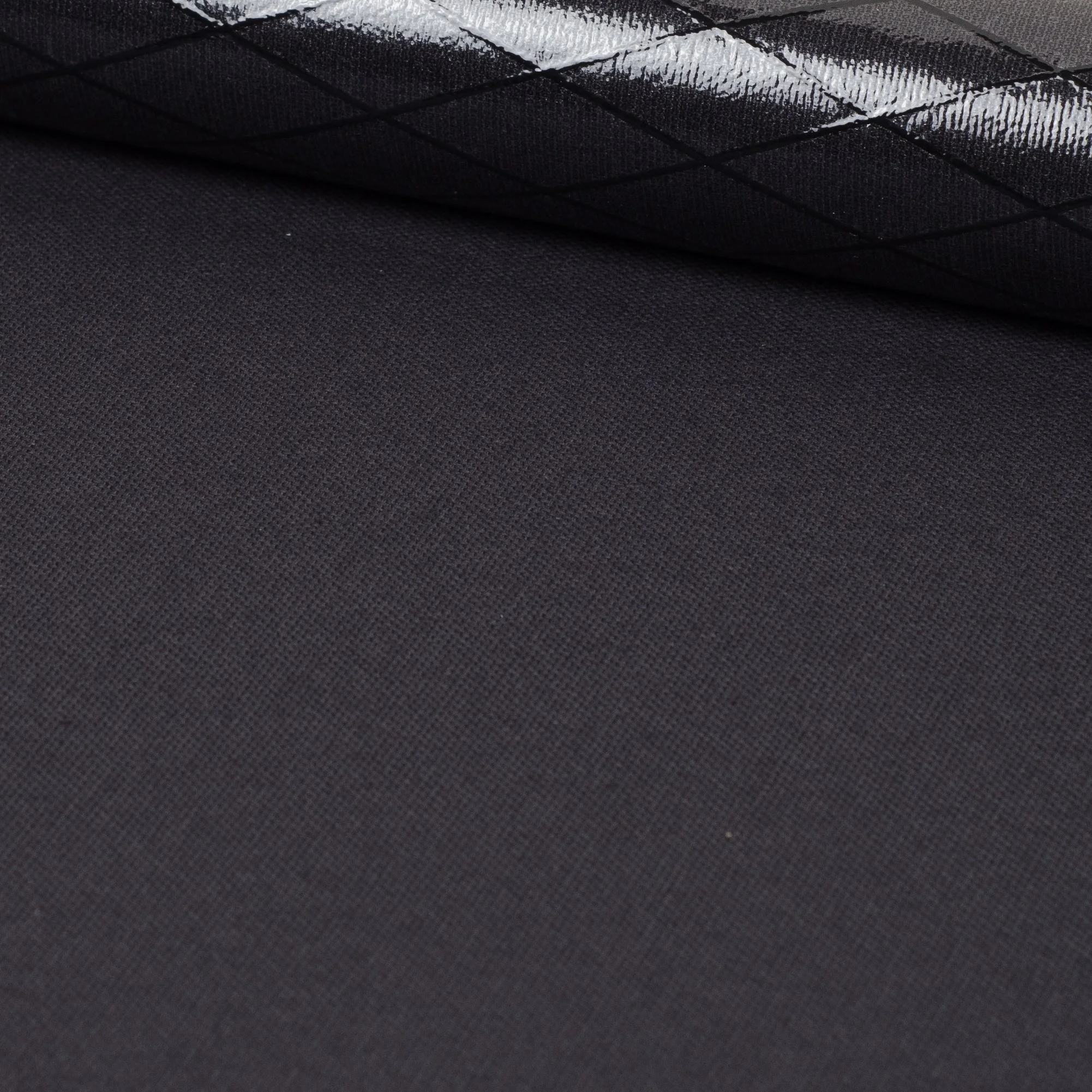 Close-up of a rolled up piece of black textured fabric.