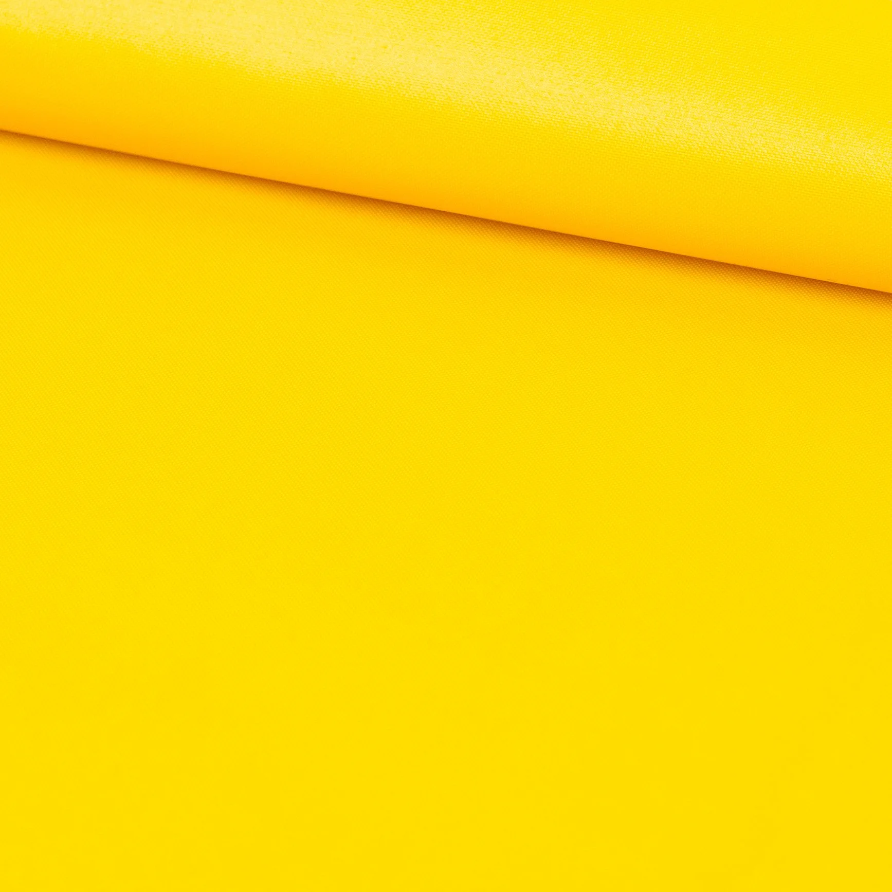 Close-up of yellow fabric with folded layers, showing a textured surface.