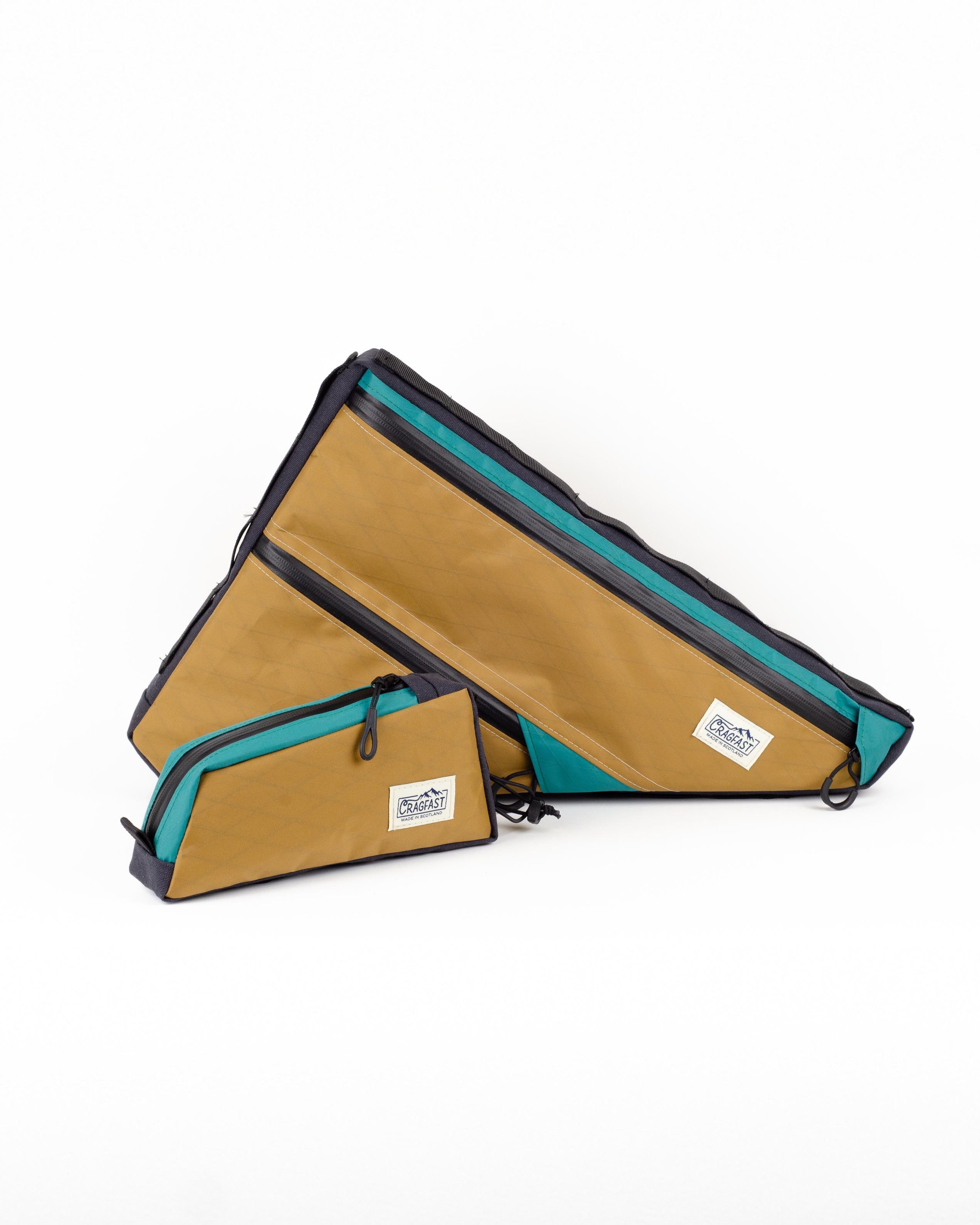 A set of tan and teal custom bike bags on a white background.