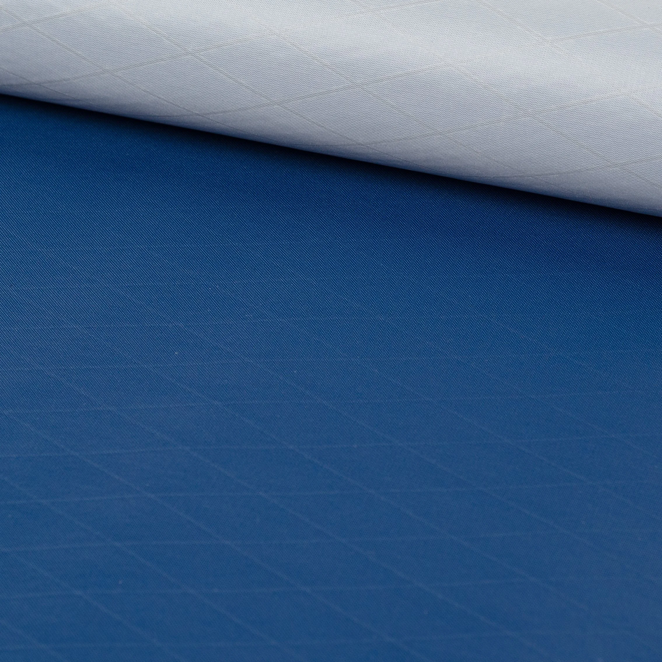 Close-up of a rolled up piece of blue textured fabric.