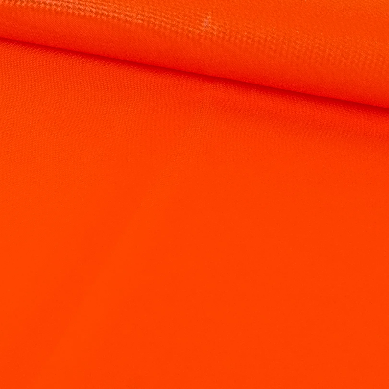 A close-up image of bright orange fabric with a slight fold or wrinkle.