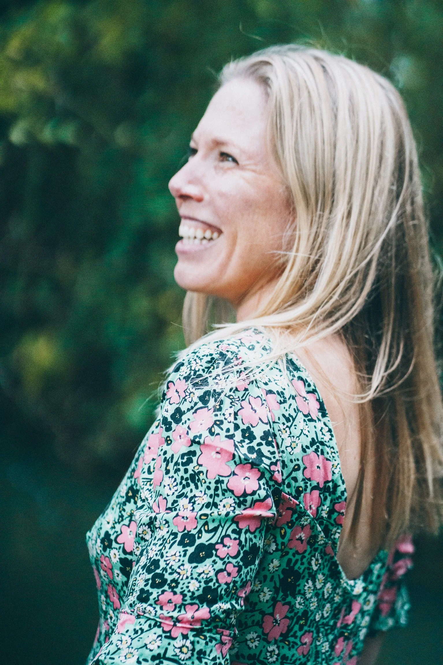 Abi Adams smiling and looking away from the camera.