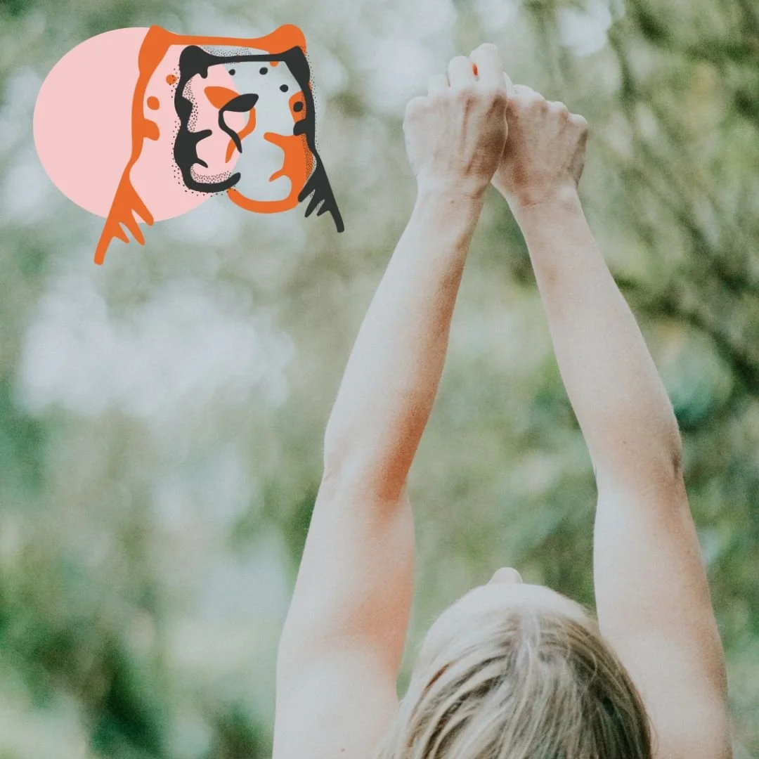 Abi Adams with her arms in the air. Her face is not visible and the photo is taken from behind her.