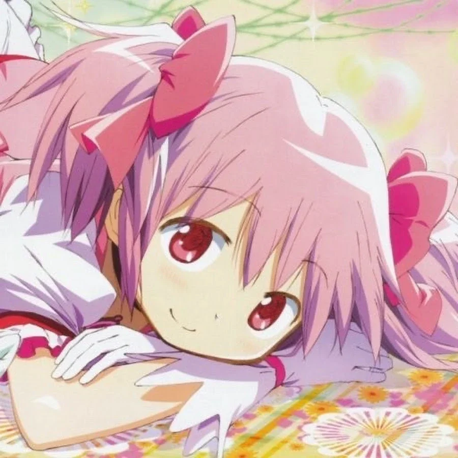 Anime girl with pink hair and large pink bows lying on a colorful floral surface, smiling gently.