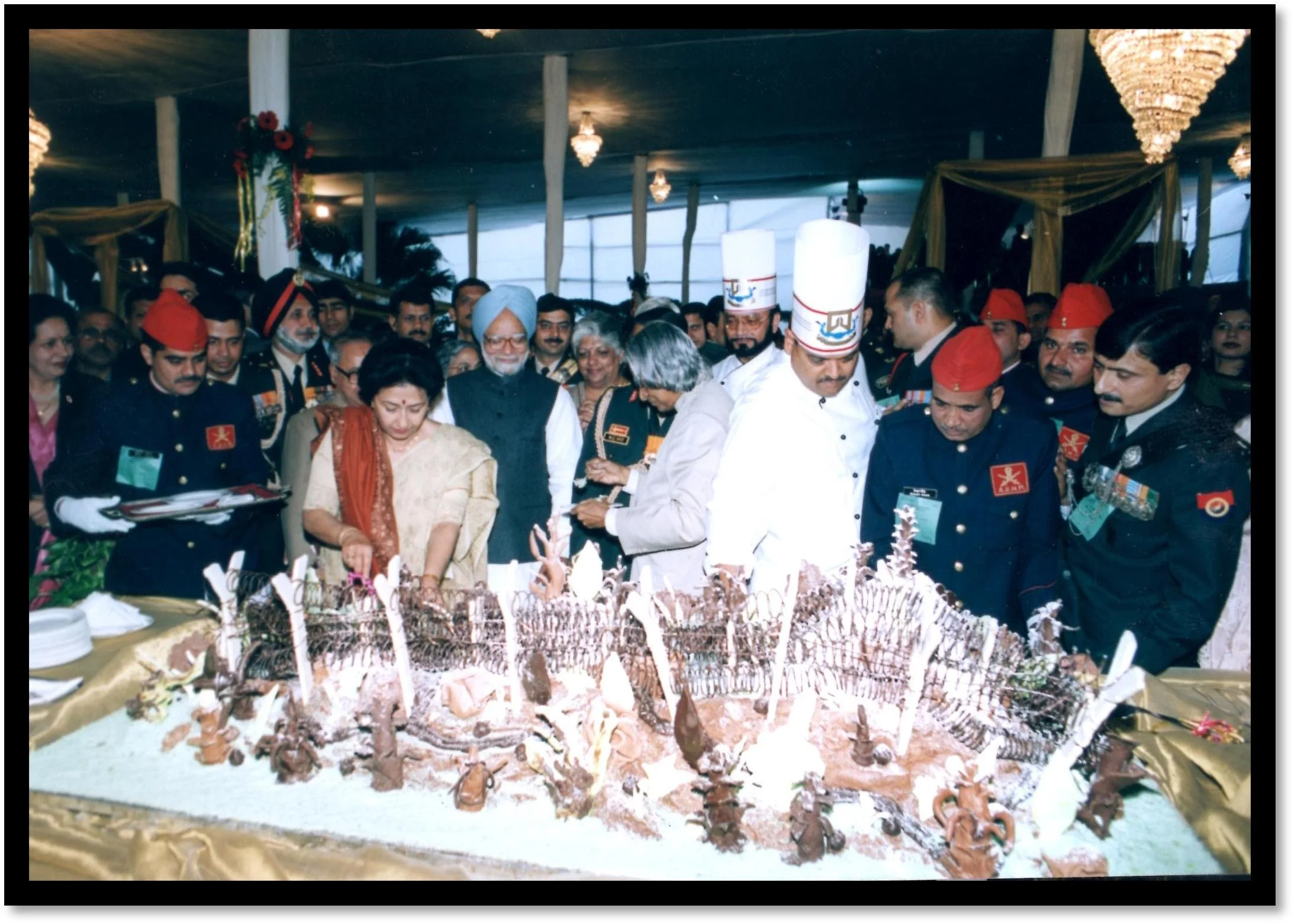 An elaborately decorated cake at a formal event. Army Day celebration, observing the cake-cutting ceremony.