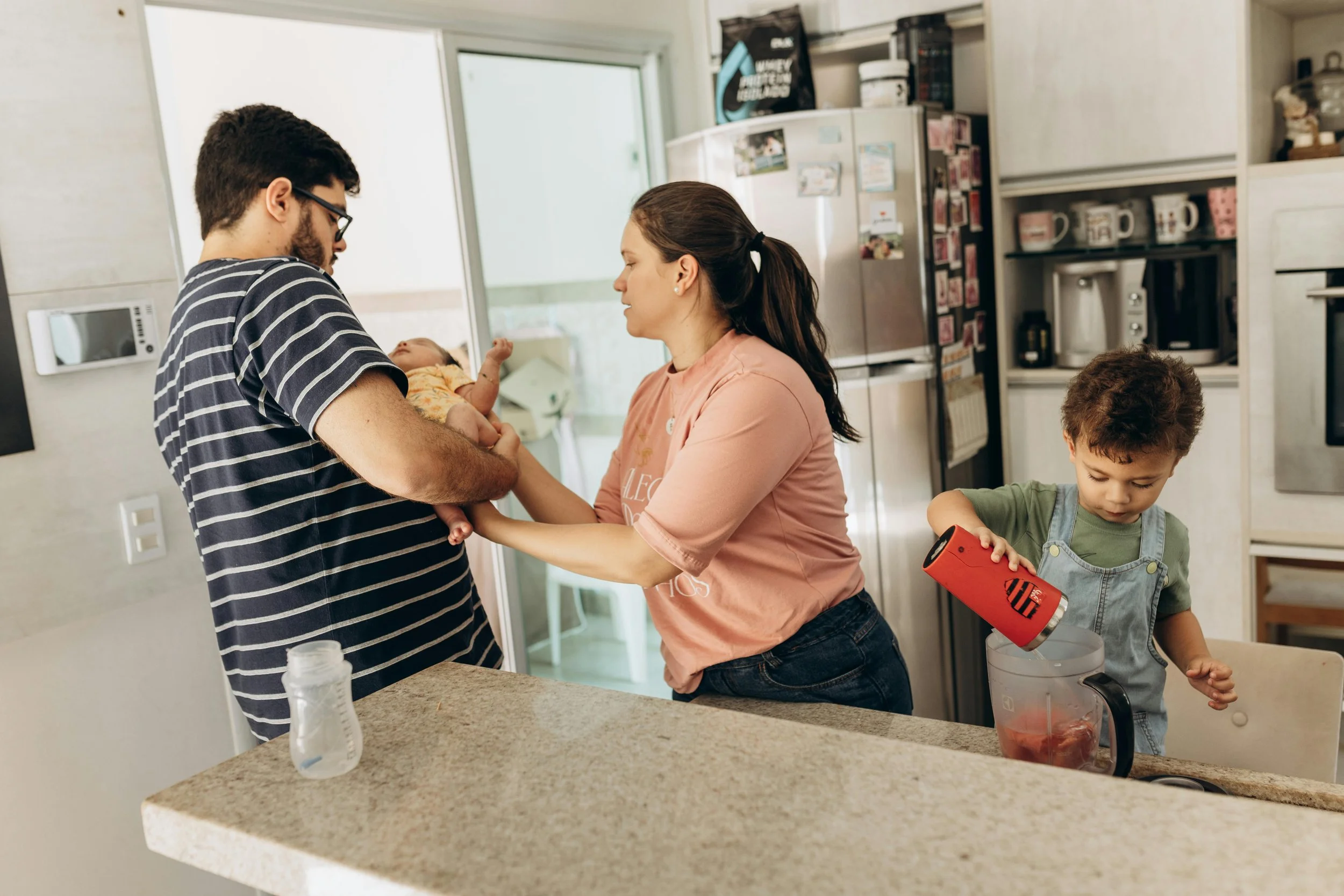 A family navigating everyday tasks together in a kitchen, representing therapy for working families and parents near El Mirage, AZ at Inside Out Therapy in Peoria