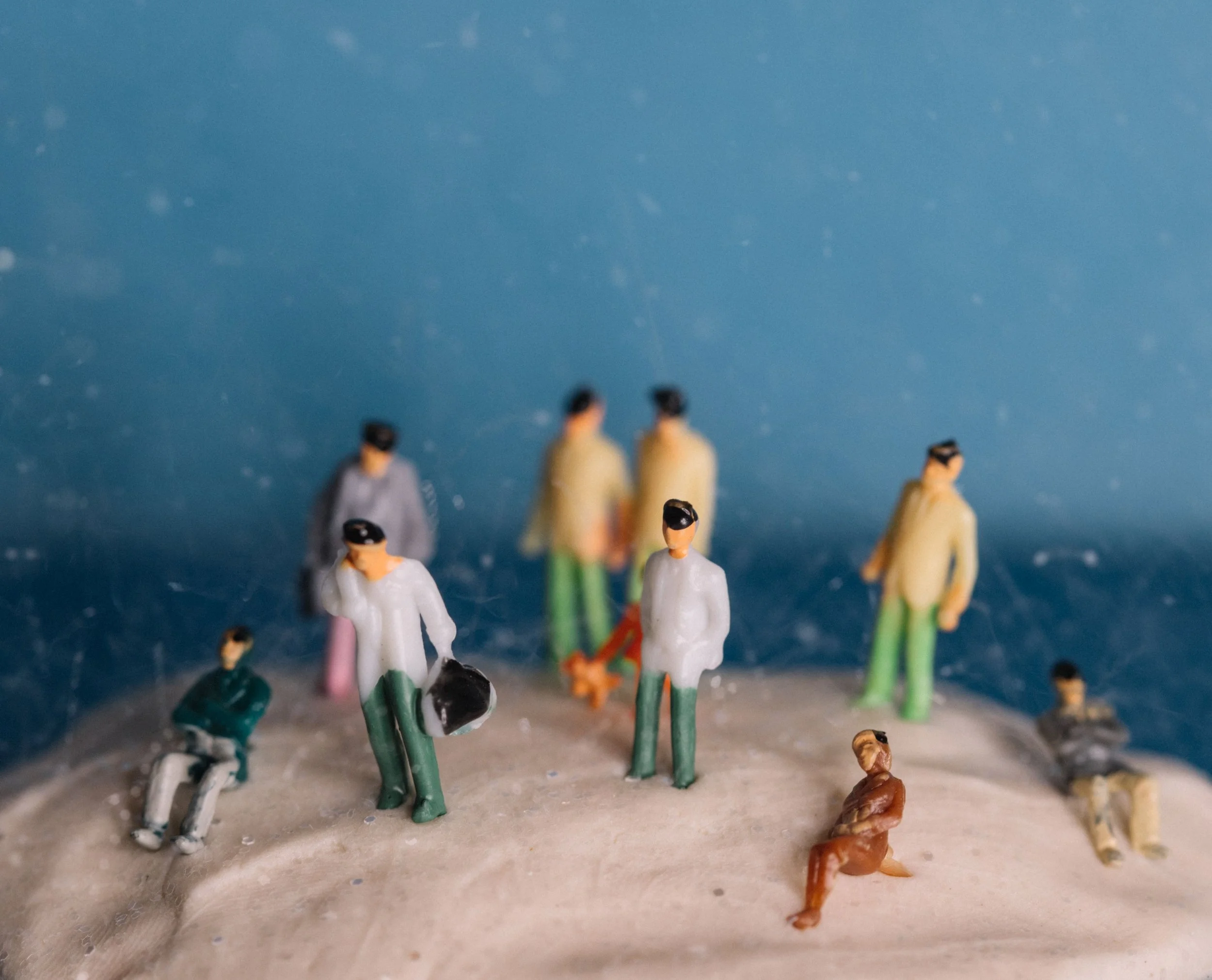 Small figurines arranged in a sand tray representing sand tray therapy for trauma at Inside Out Therapy and Consulting in Peoria, AZ