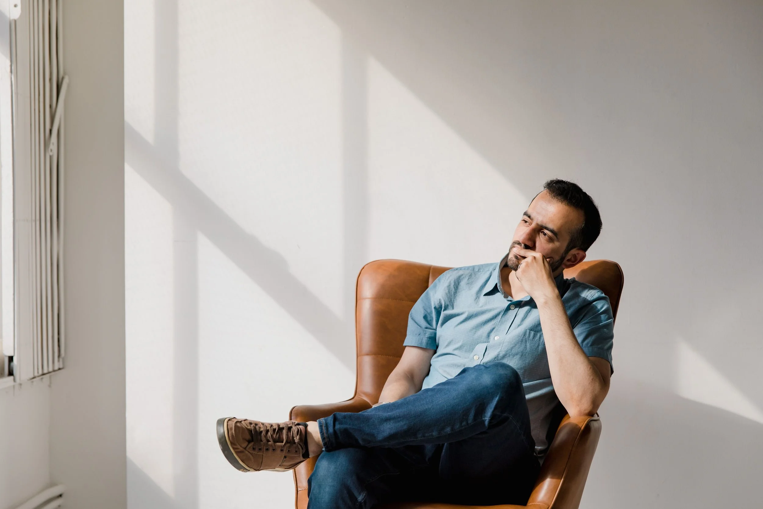 A person sitting quietly in a calm, warm setting representing faith-affirming therapy and healing at Inside Out Therapy and Consulting in Peoria, AZ