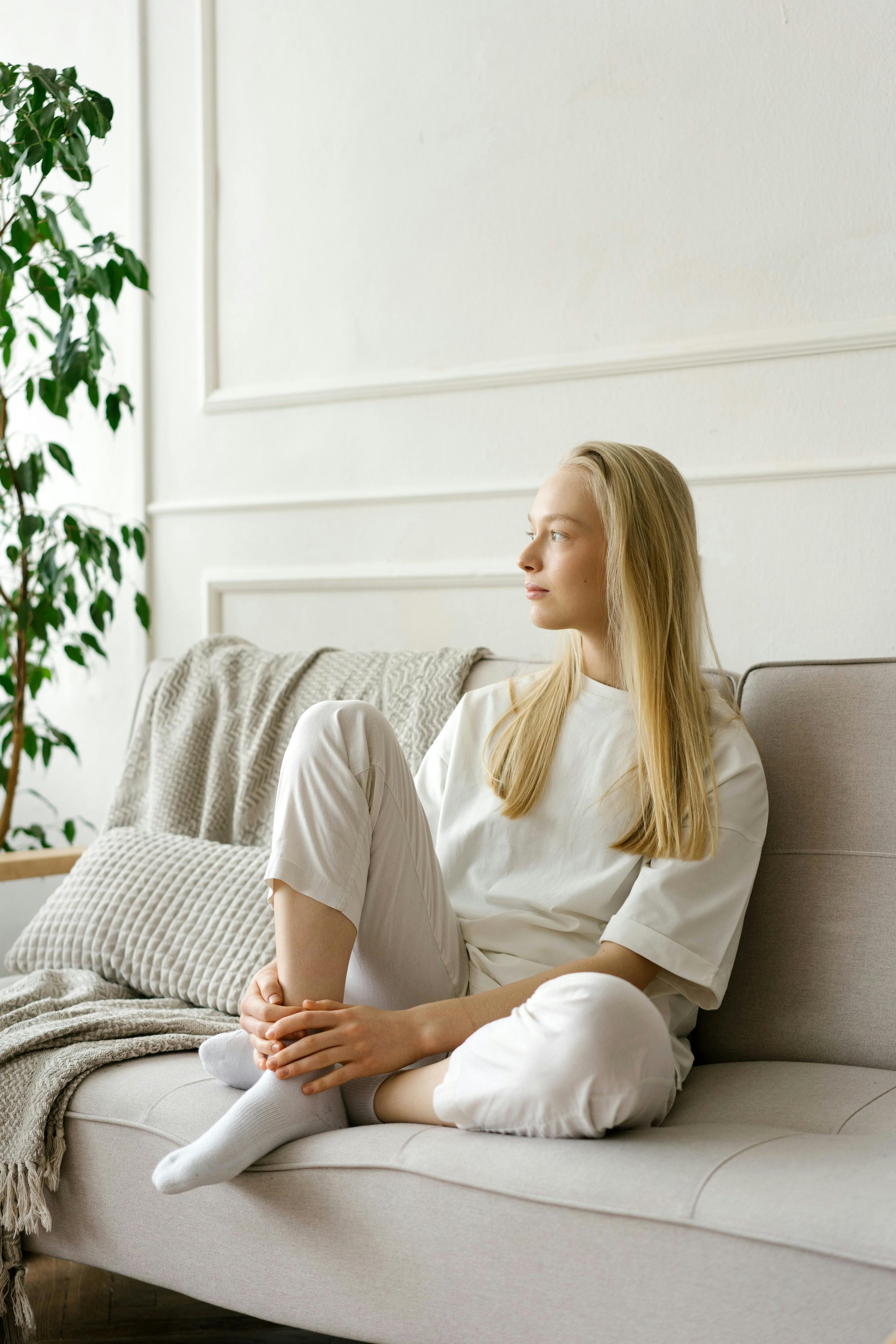 A teenage girl sitting on a couch in a therapy setting, representing teen and adolescent therapy at Inside Out Therapy and Consulting serving Buckeye, AZ