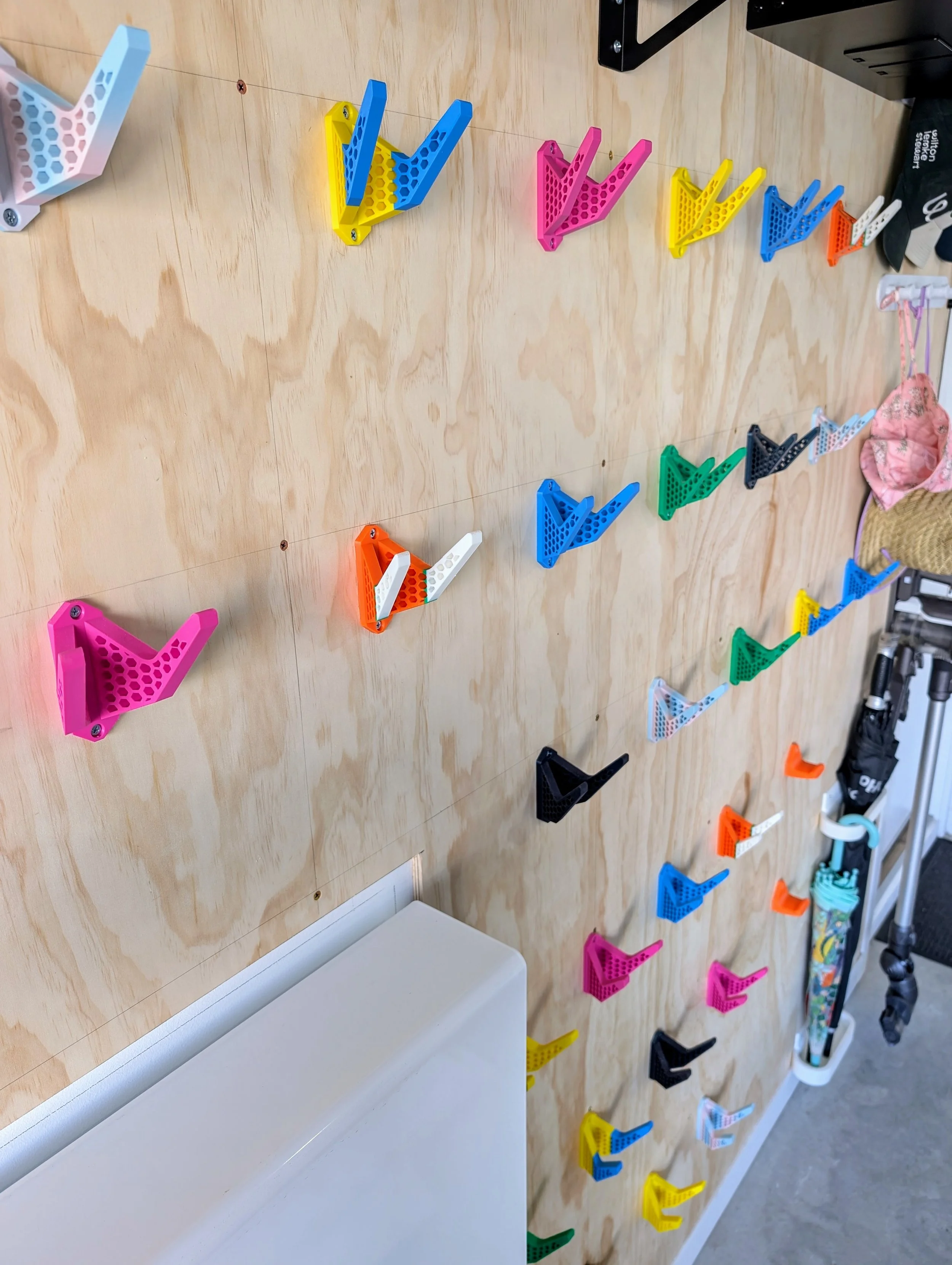 Colorful plastic climbing holds attached to a wooden climbing wall
