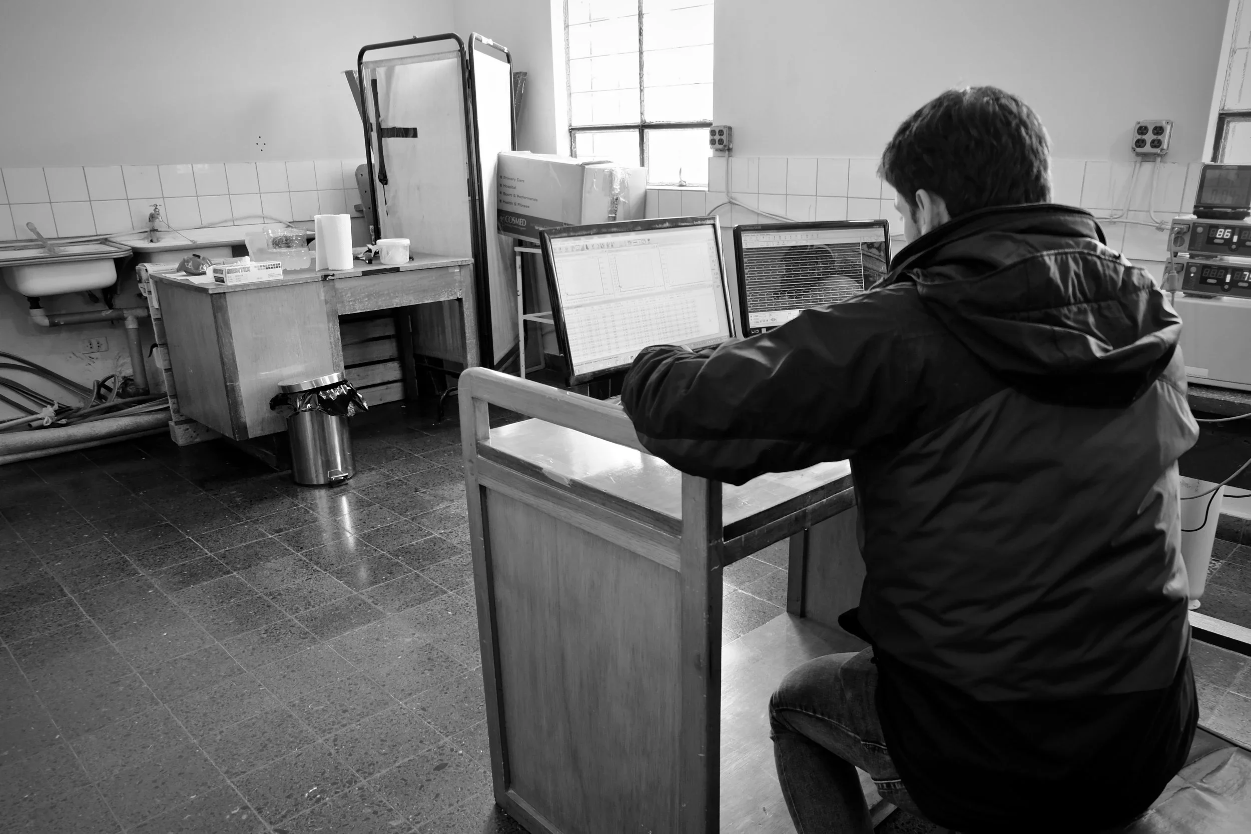 Dr. Francisco Villafuerte analyzes data during a study participant's biking session.