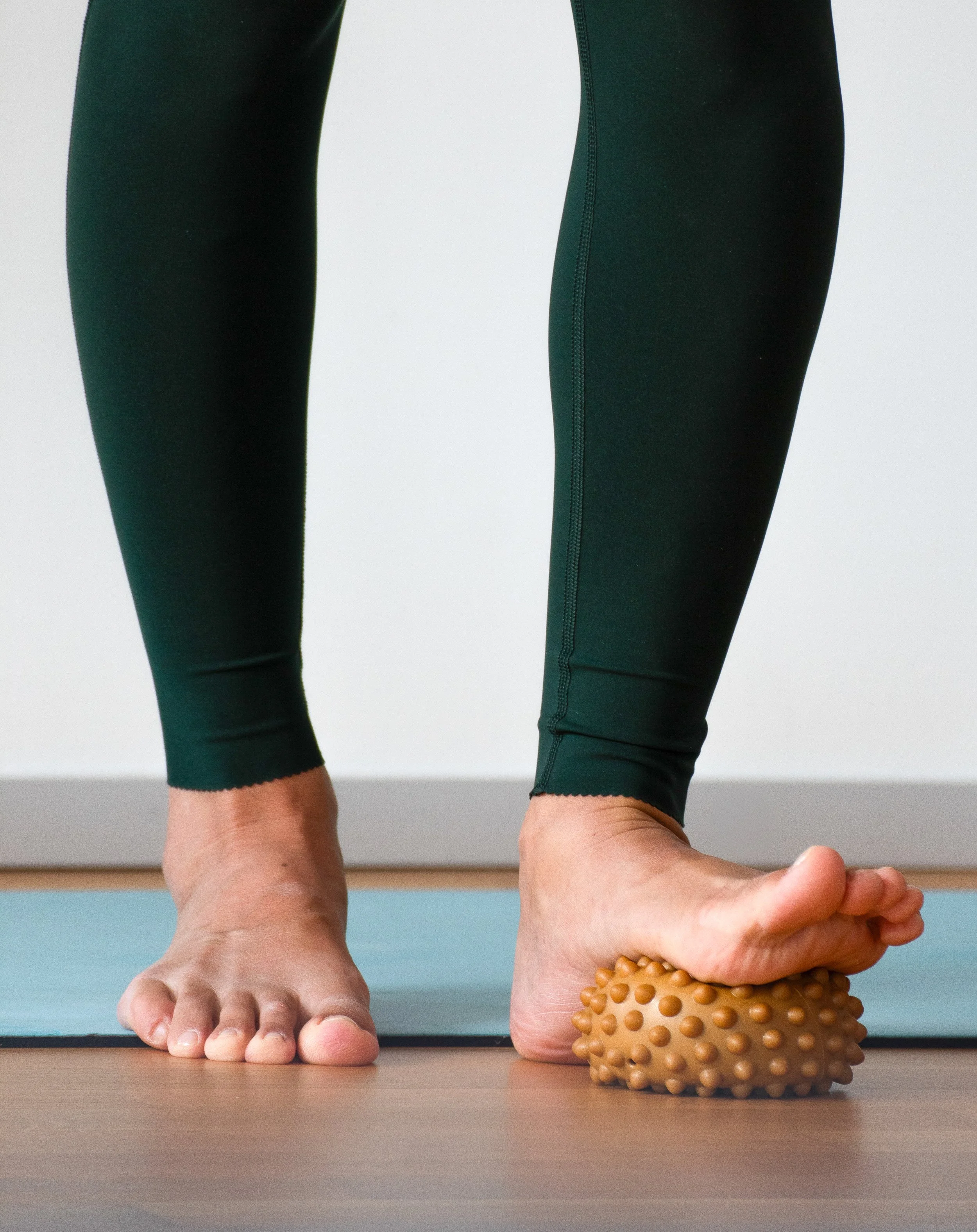 Feet massaging on pilates ball