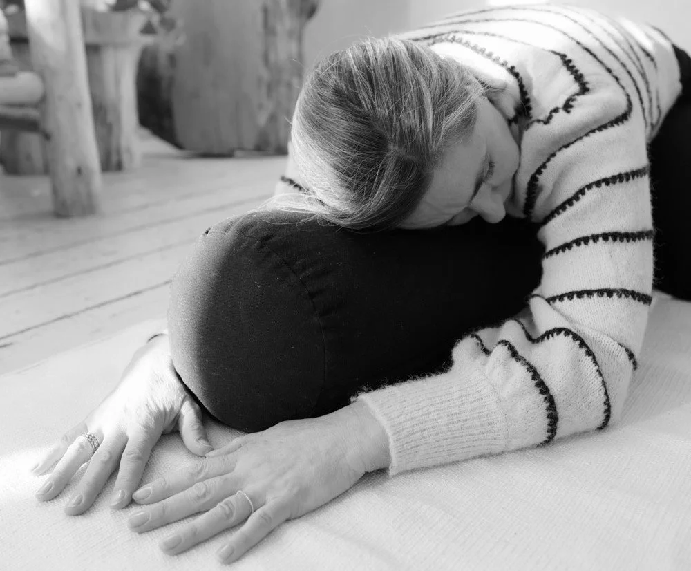 Close up of yoga teacher Marlijn in a supported child's pose, Balasana