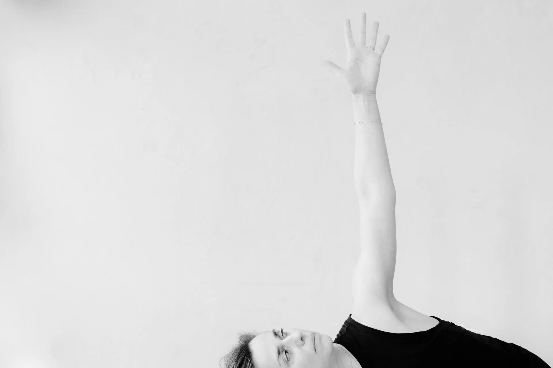 Close up of face and arm of yoga teacher Marlijn in a Half Moon pose