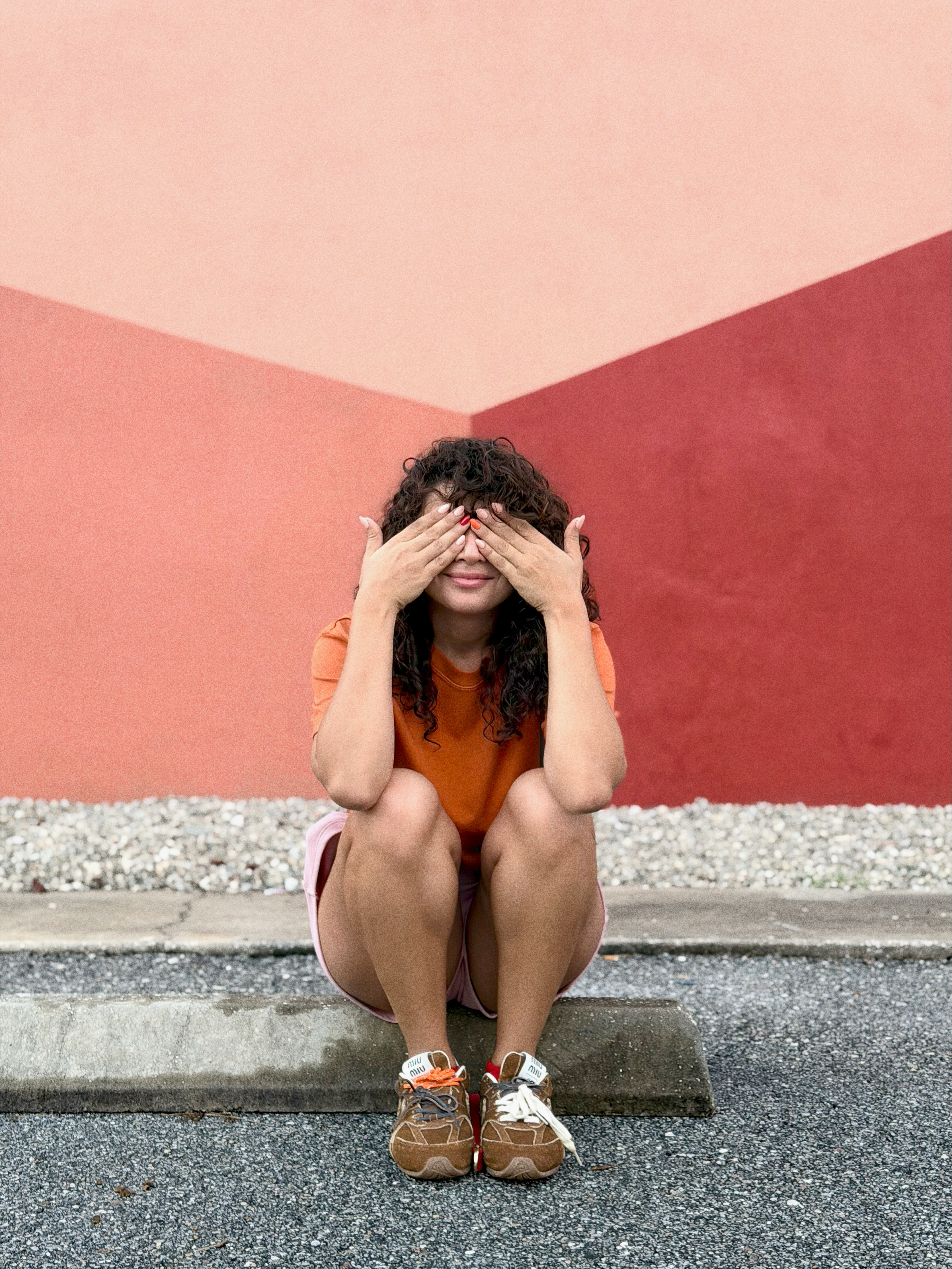Laurie’s customers, Mariana and Carmen holding hands on a green lawn on their wedding day.