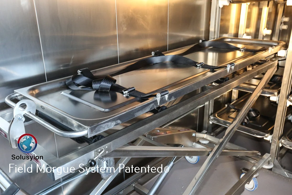 Body tray lined up. Trays have three retention straps along the length of the tray for rock solid security when transporting the morgue when full.