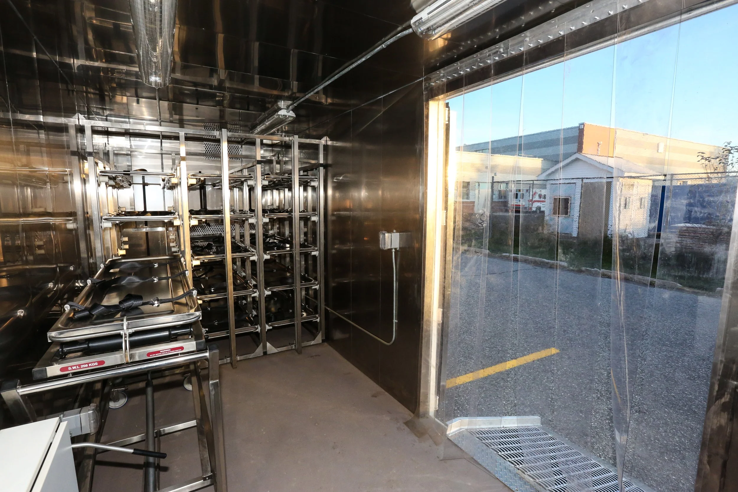 View of interior showing racking, body lift and door access leading to exterior