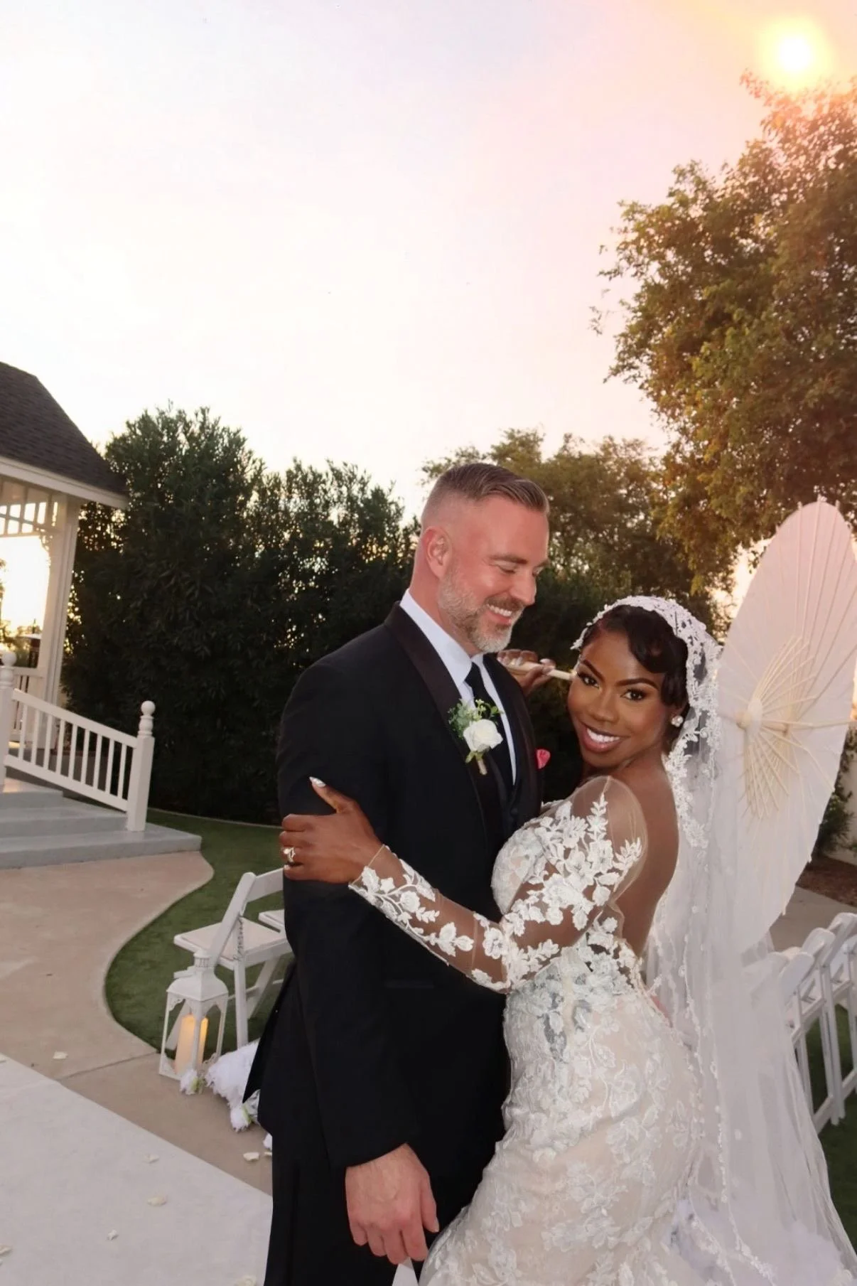 Laurie’s customers, Fernando and Kate embracing by the lake on their wedding day.