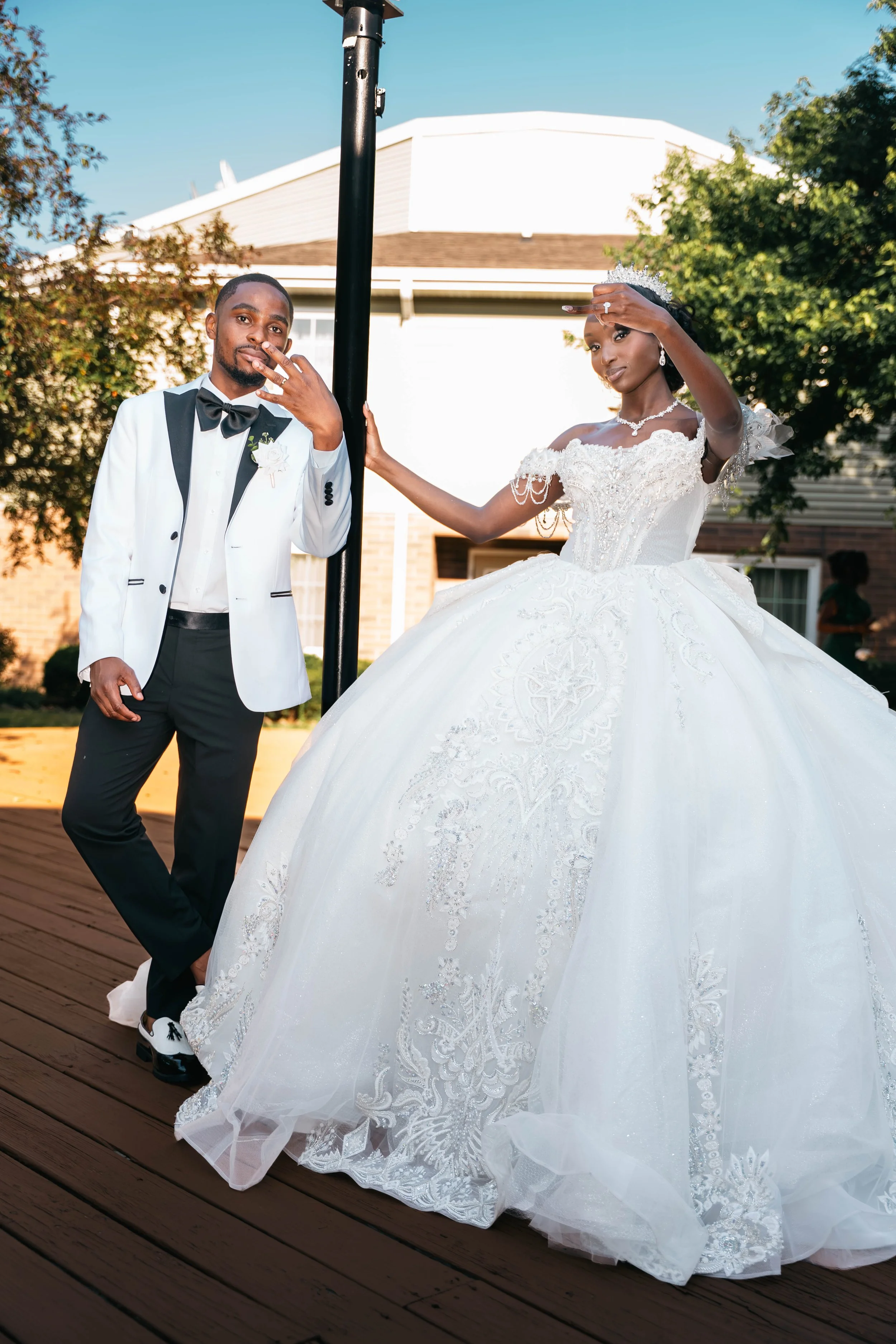 Laurie’s customers, Mariana and Carmen holding hands on a green lawn on their wedding day.