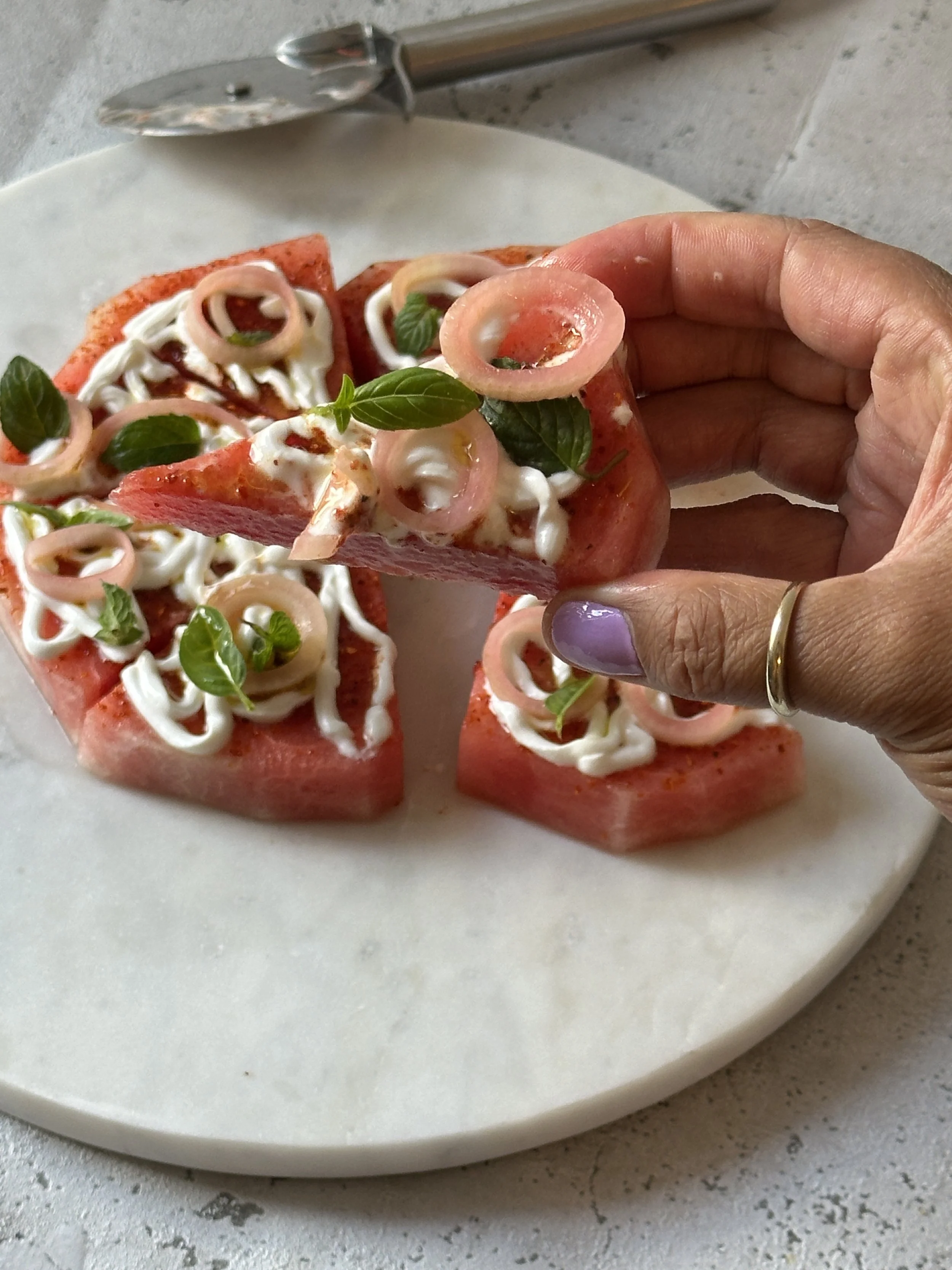Watermelon salad with sour cream and pickled onion