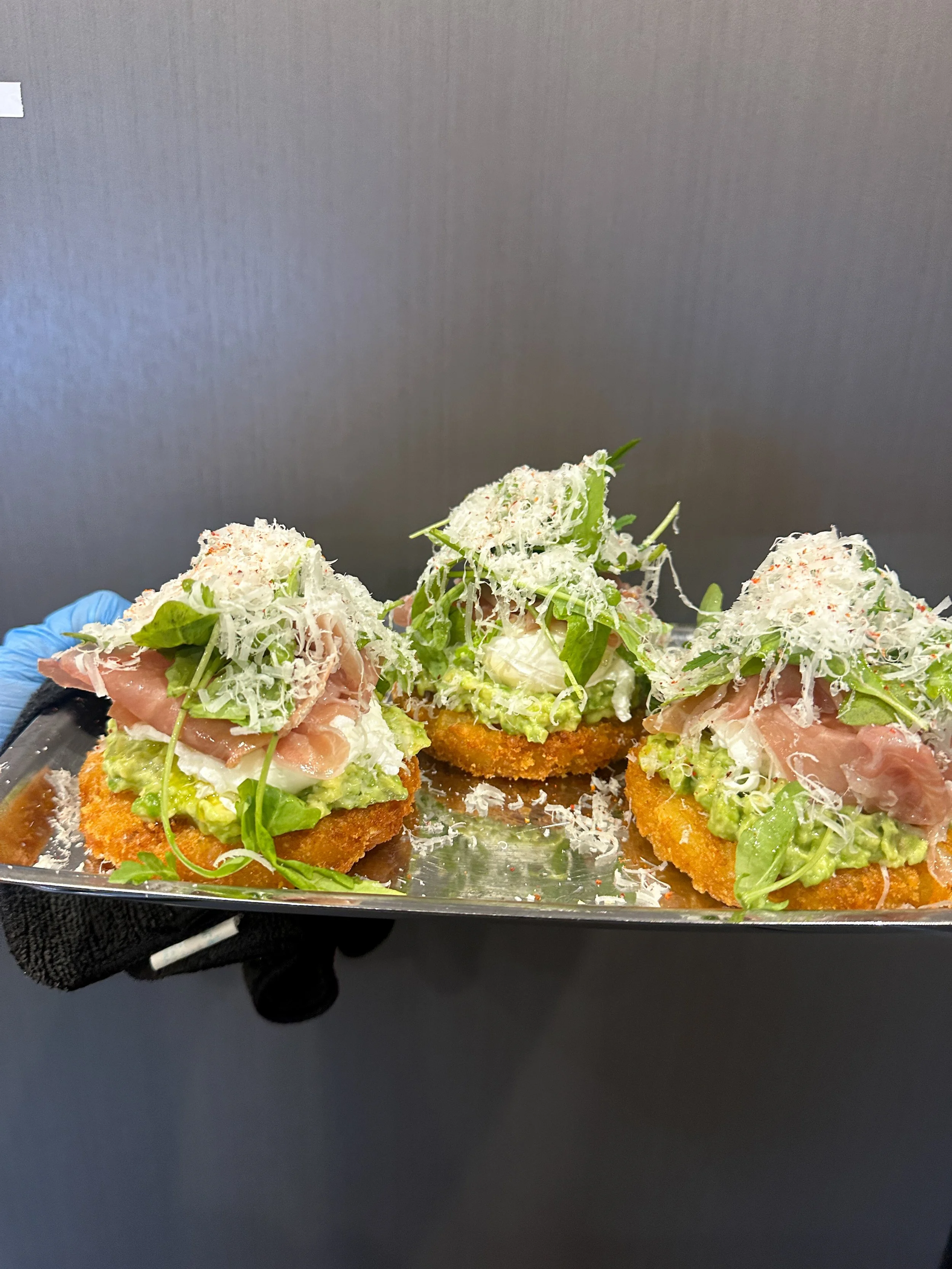 Hashbrown, avocado, poached eggs, speck and parmesan 