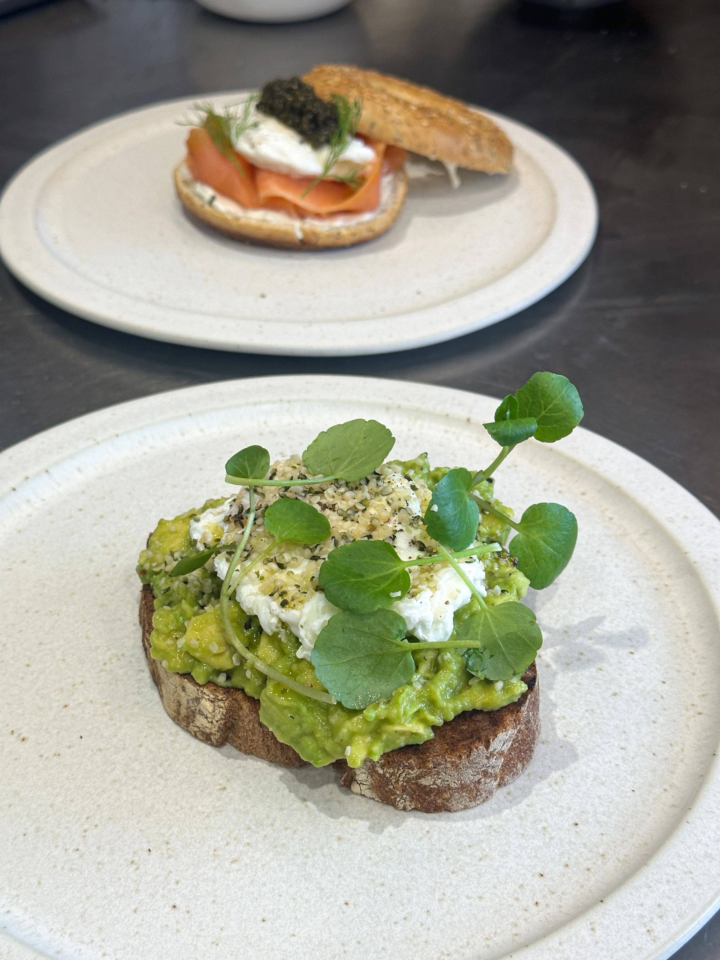 Smashed avocado on sourdough with poached egg and watercress