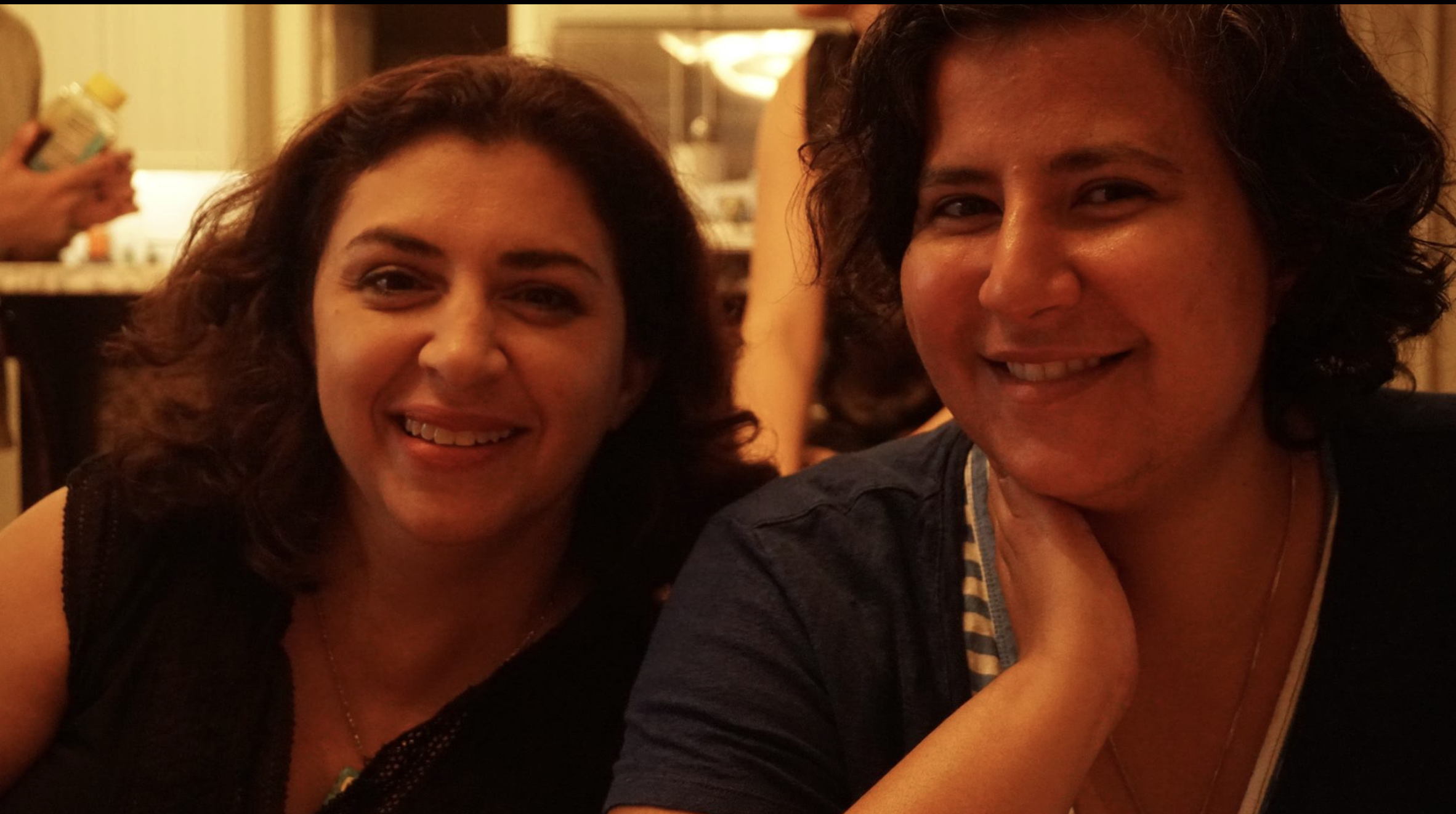 Two women looking at the camera smiling