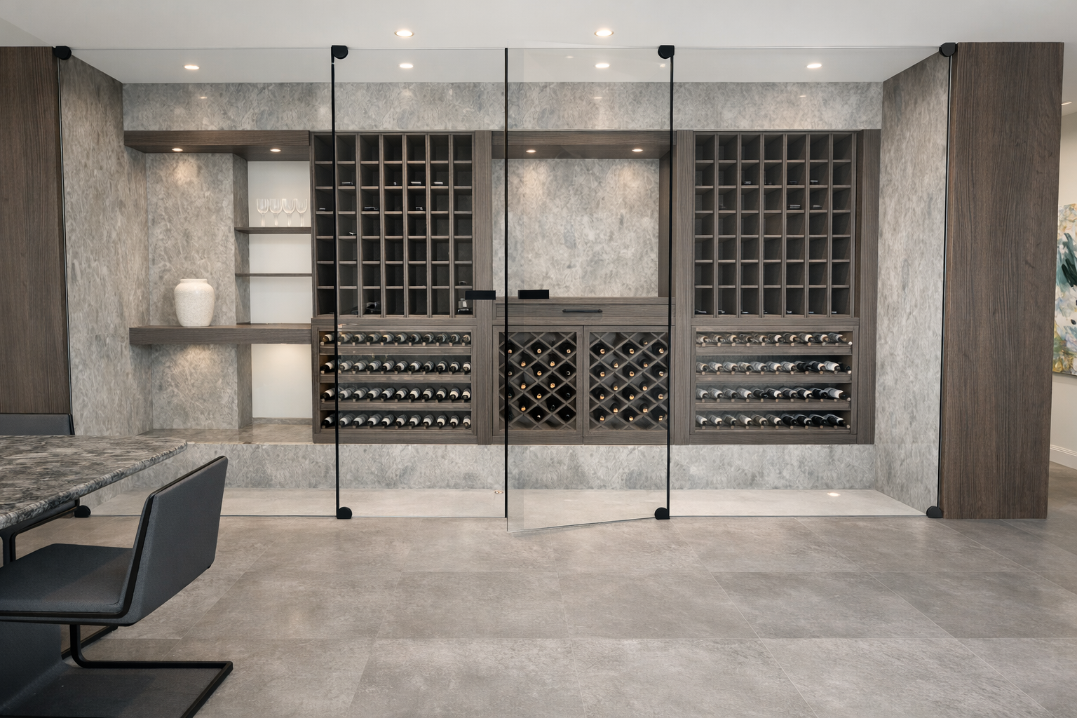 Wine Cellar Room interior at Villa, Monaco designed by Ursula Carlton Design, featuring Dekton cladding, custom veneer cabinetry, and modern glass doors.