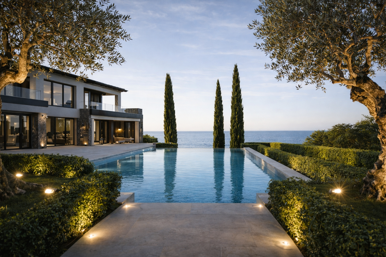 Exterior view of villa in Monaco with an infinity pool and landscaped gardens overlooking the Mediterranean sea.