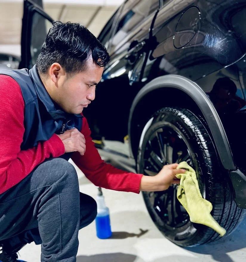 Professional car lot cleaning at a dealership, preparing vehicles for immediate sale.