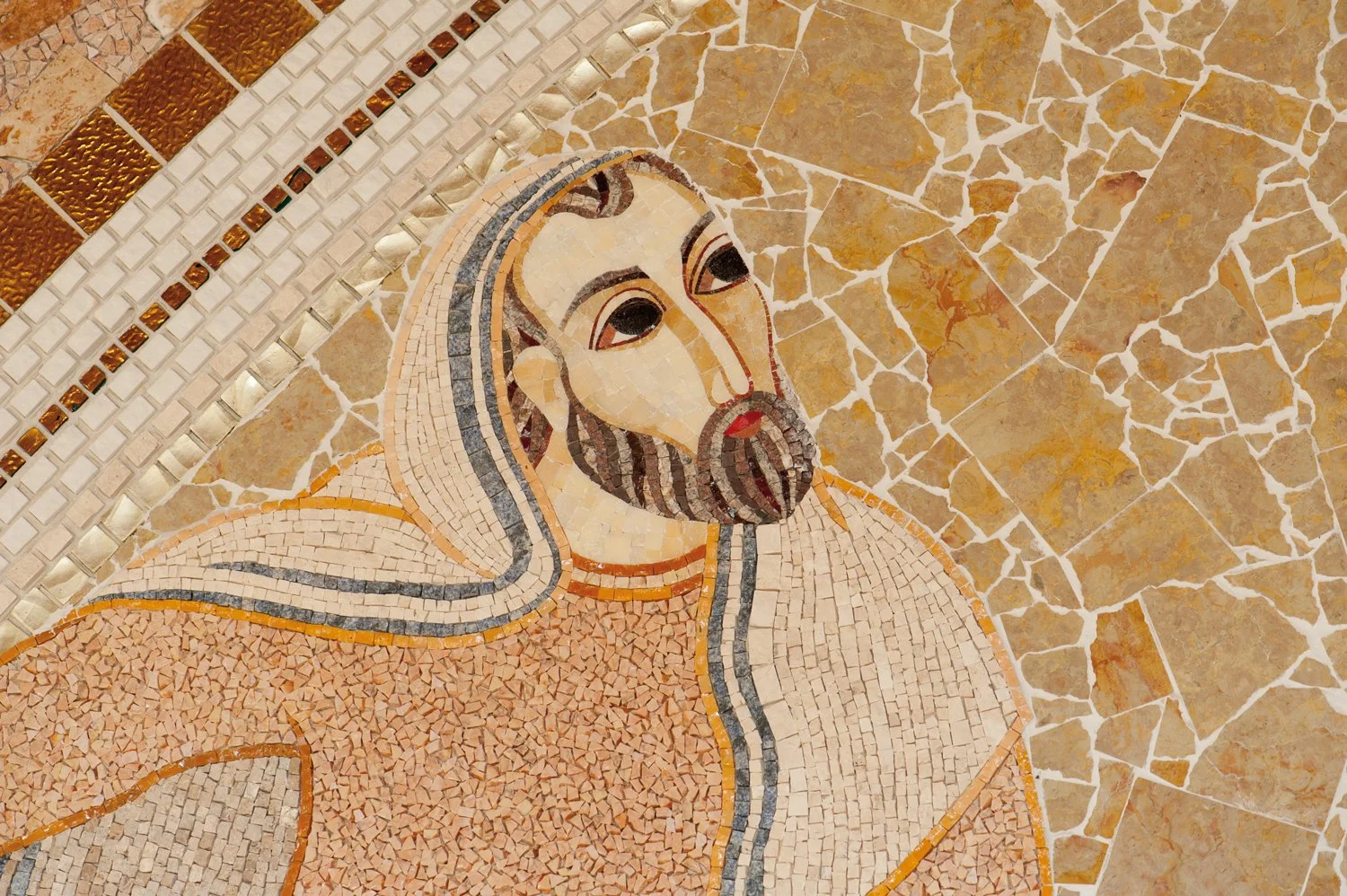 Mosaic of Jesus Christ with long hair and beard, depicted with a solemn expression, surrounded by various colored tiles in a mosaic art style.