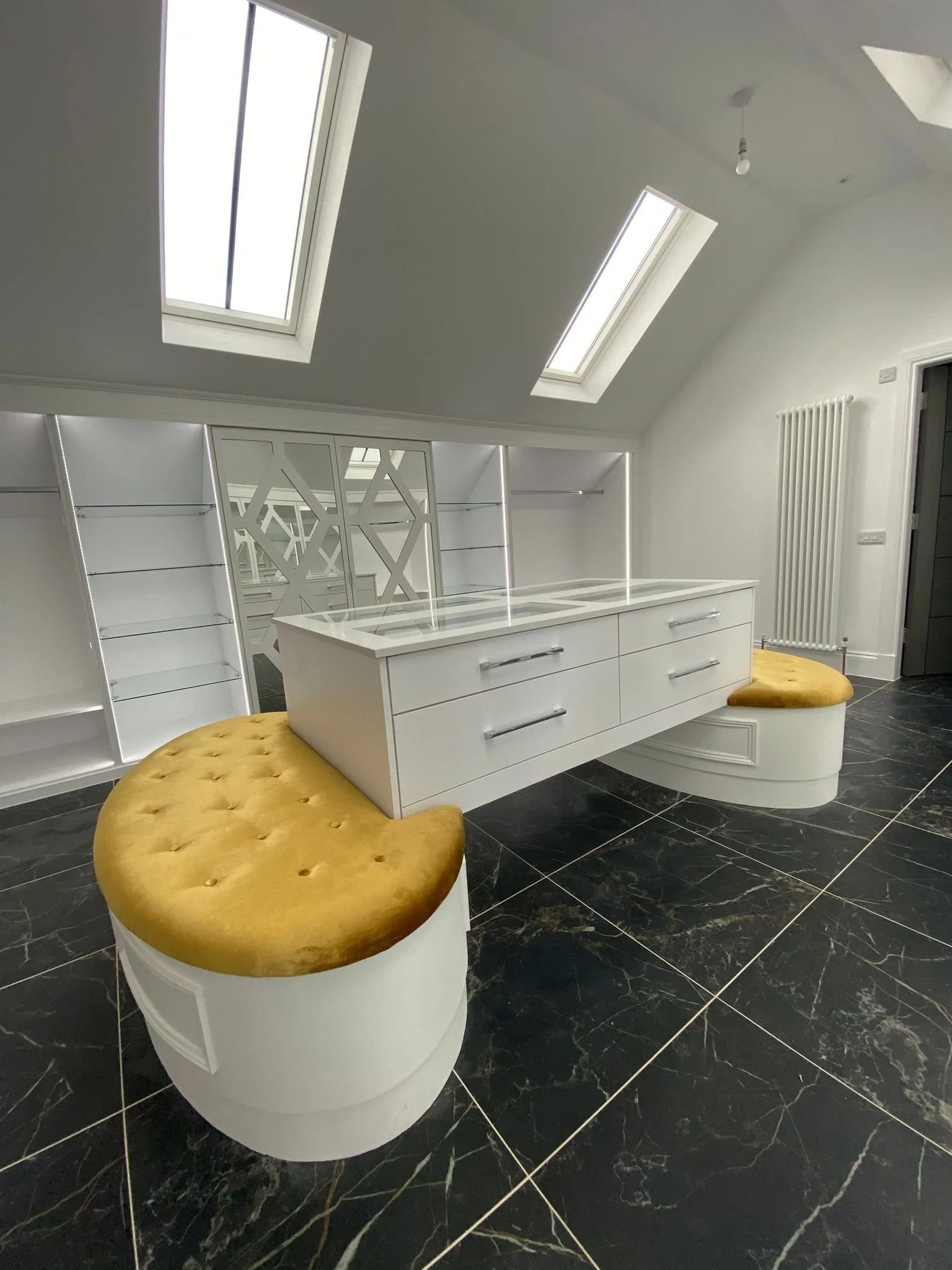 Bespoke walk-in wardrobe with feature central display cabinet.