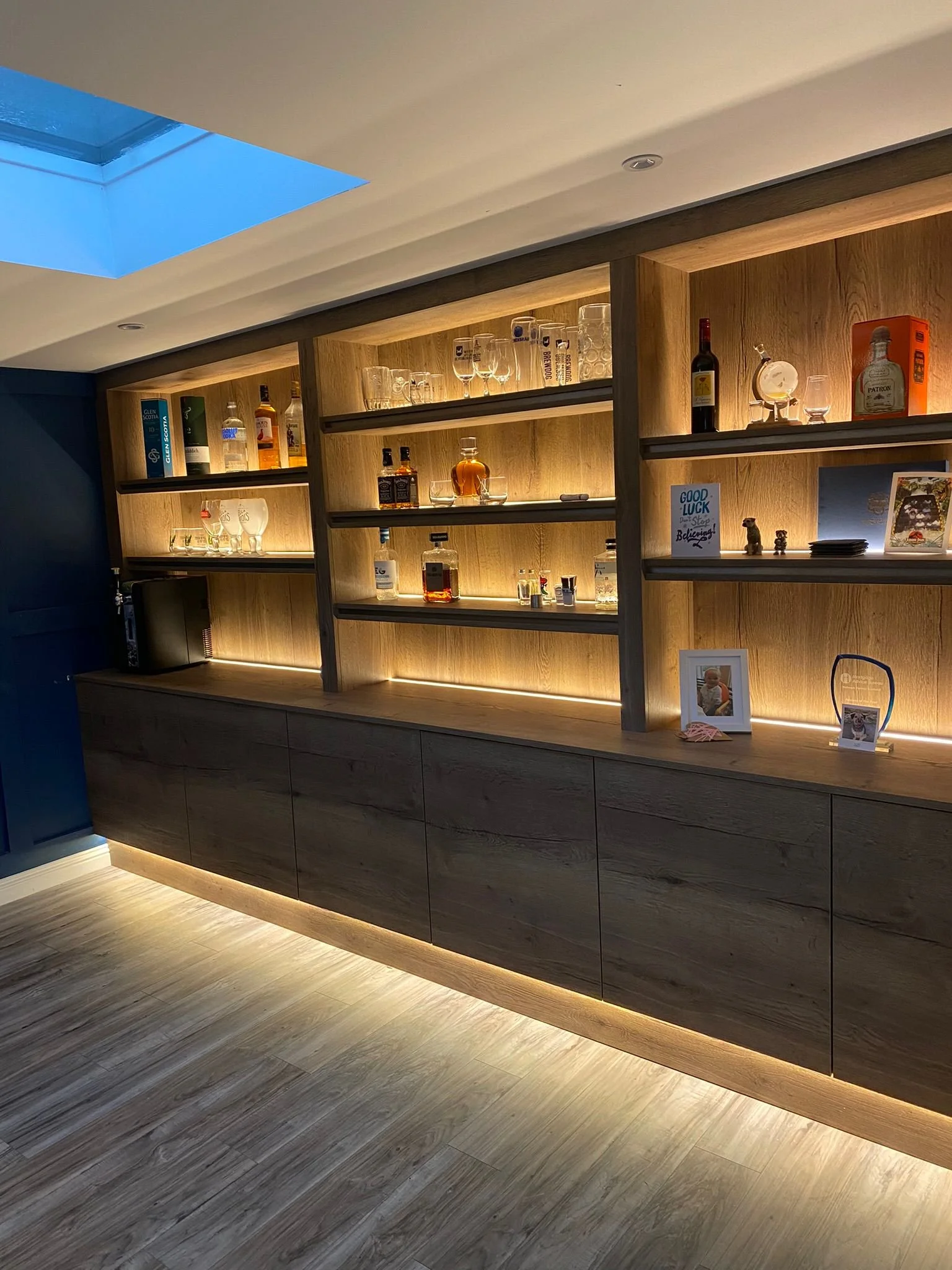 Full width wall cabinetry with drinks display and LED lighting