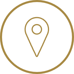 Icon of a location pin on a black background with a gold outline.