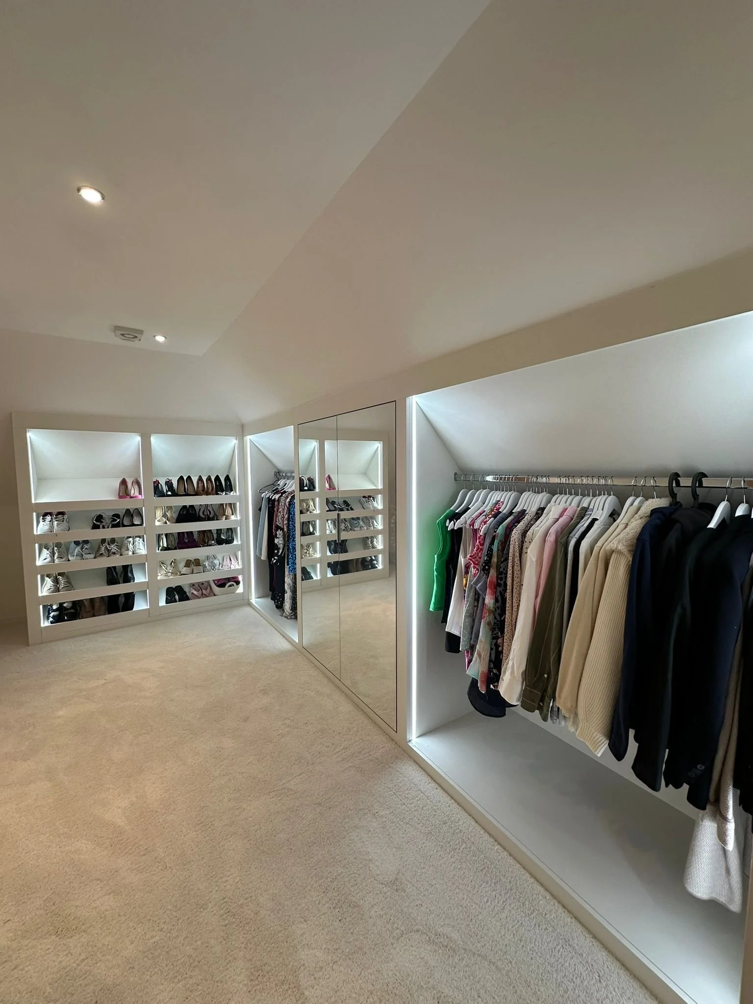 Open eaves storage with hanging rails and LED shoe storage. 