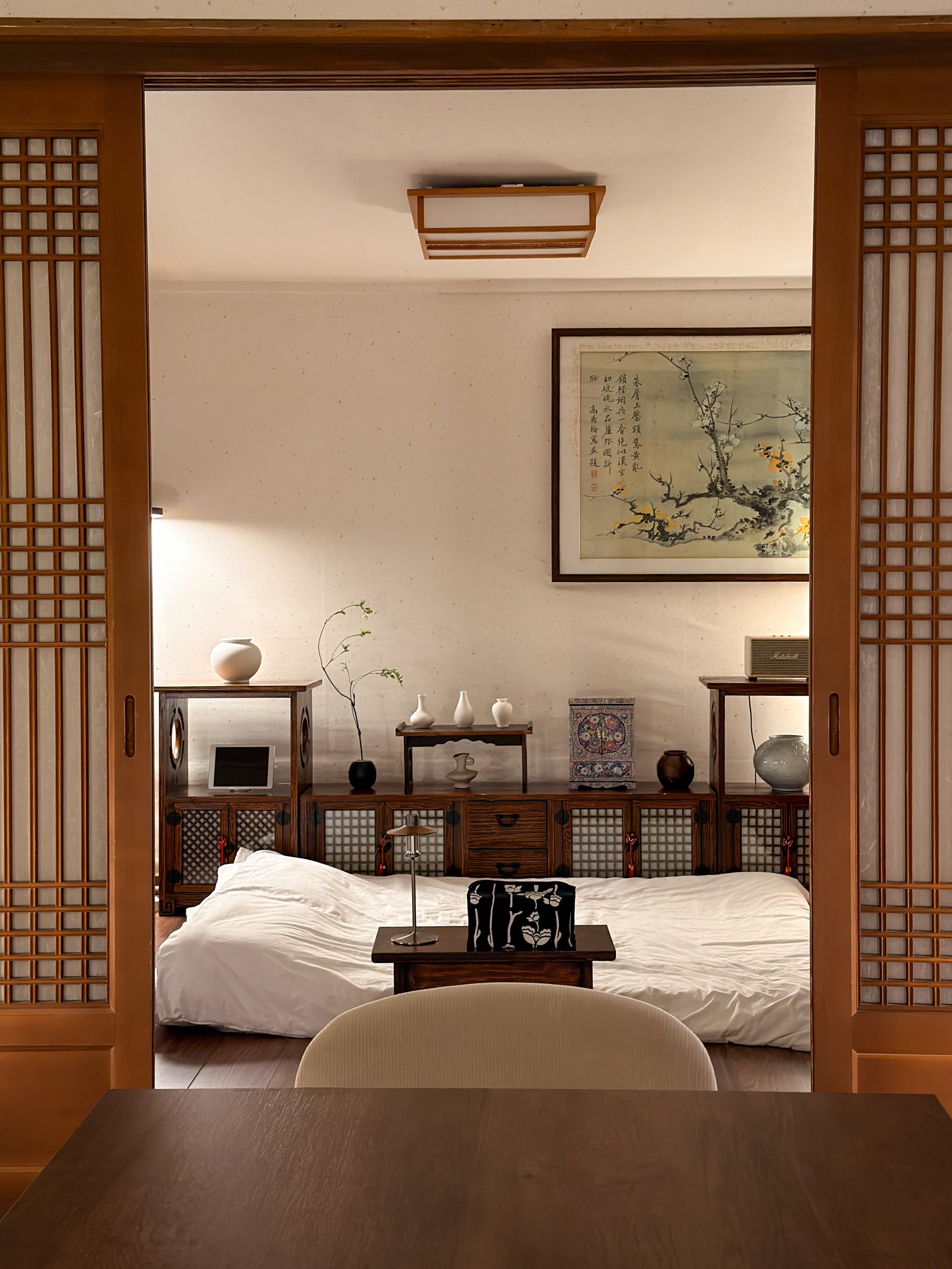 Field of white daisies with yellow centers swaying in the breeze during sunset.