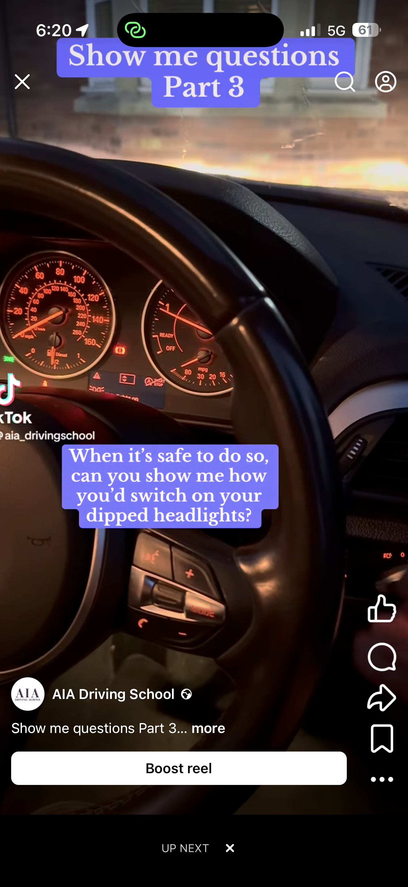 The image shows the dashboard of a car with the speedometer, tachometer, and fuel gauge visible. The steering wheel is in the foreground, and the background shows a sunset or sunrise scene outside the vehicle. Overlaid text asks about switching on dipped headlights.
