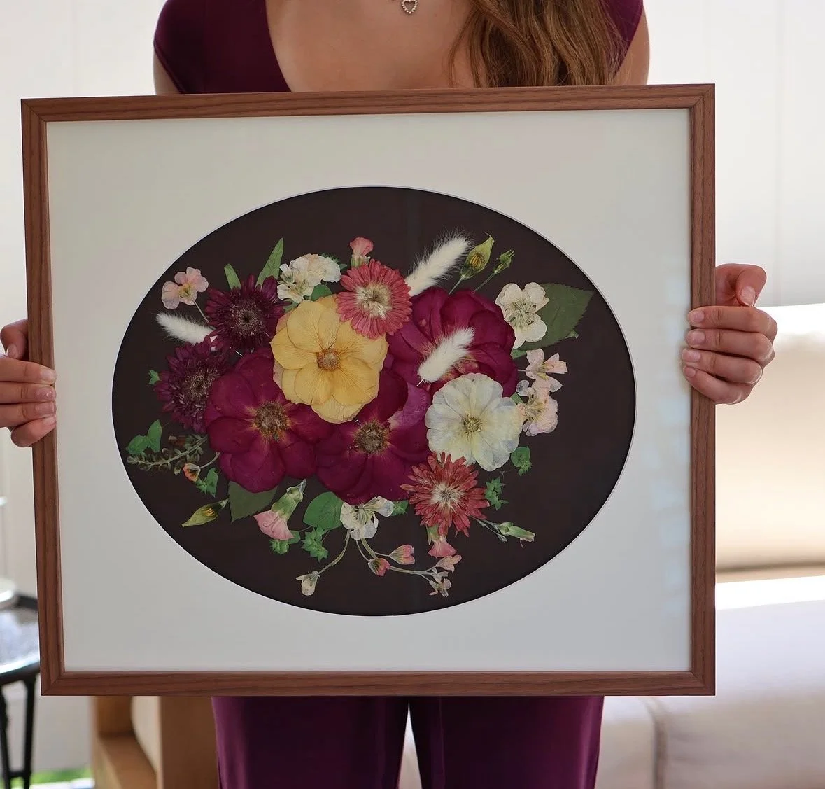 Framed flower art with vibrant pink, orange, yellow, and white flowers on a black background