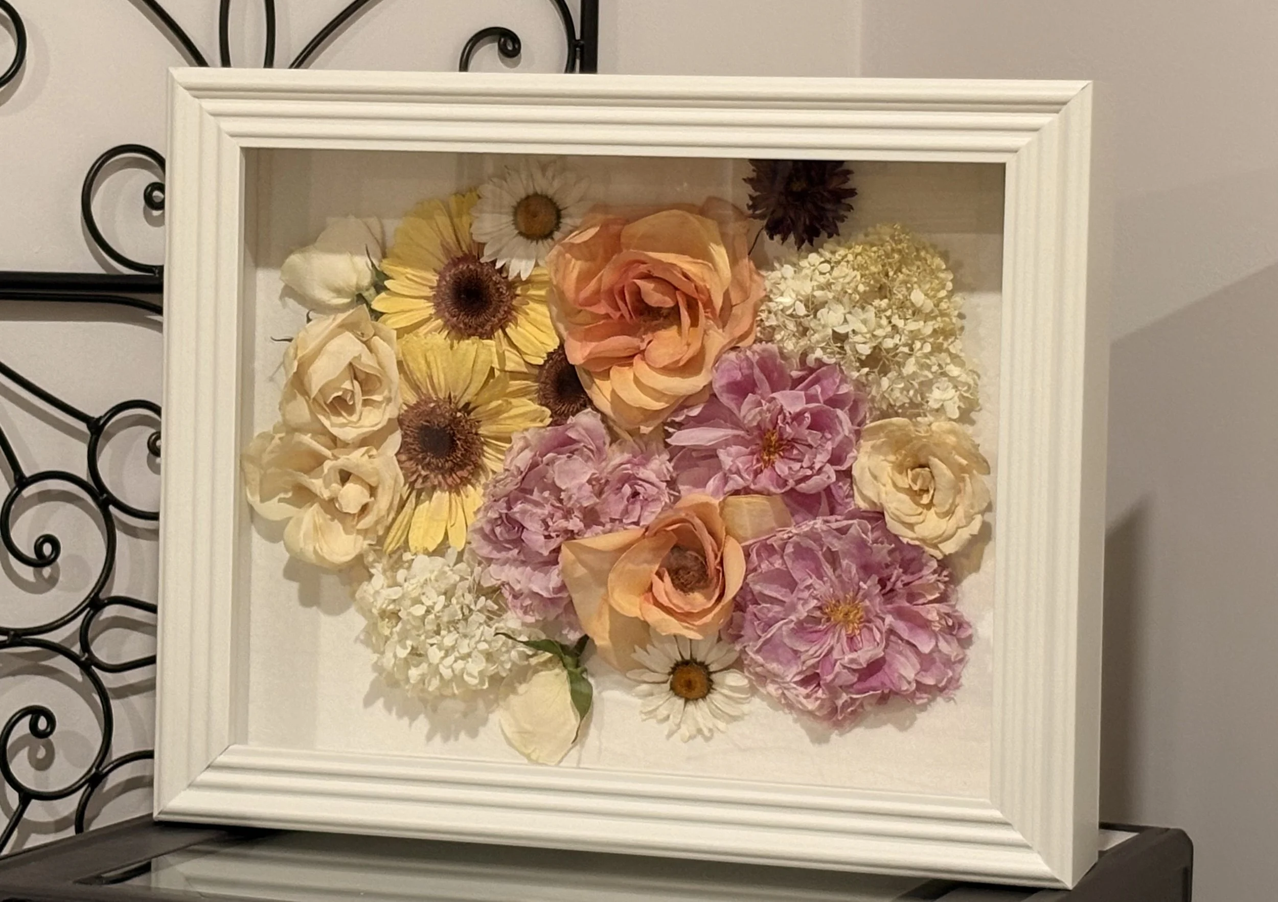 Framed display of dried flowers framed in a shadowbox