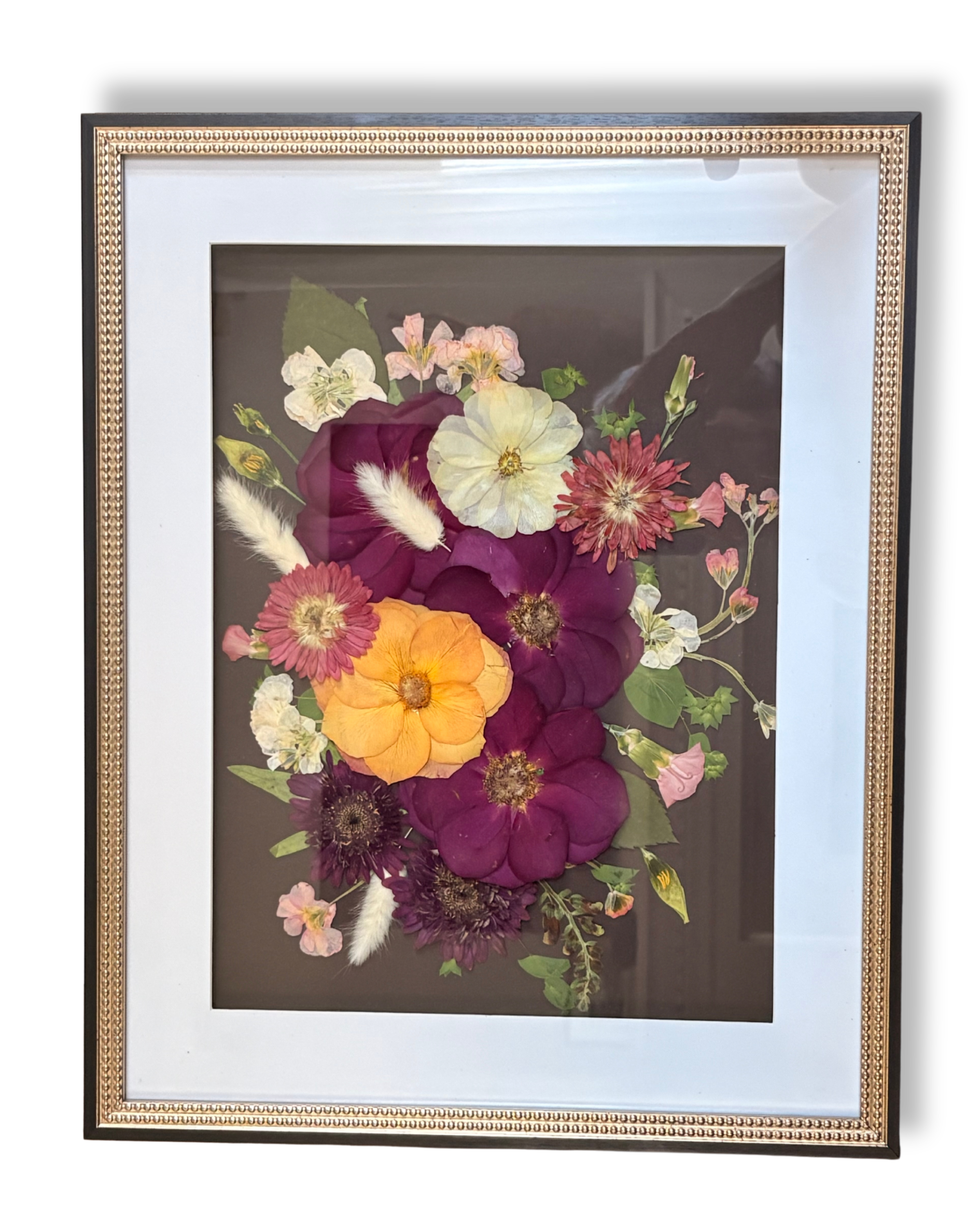 Framed flower art with vibrant pink, orange, yellow, and white flowers on a black background