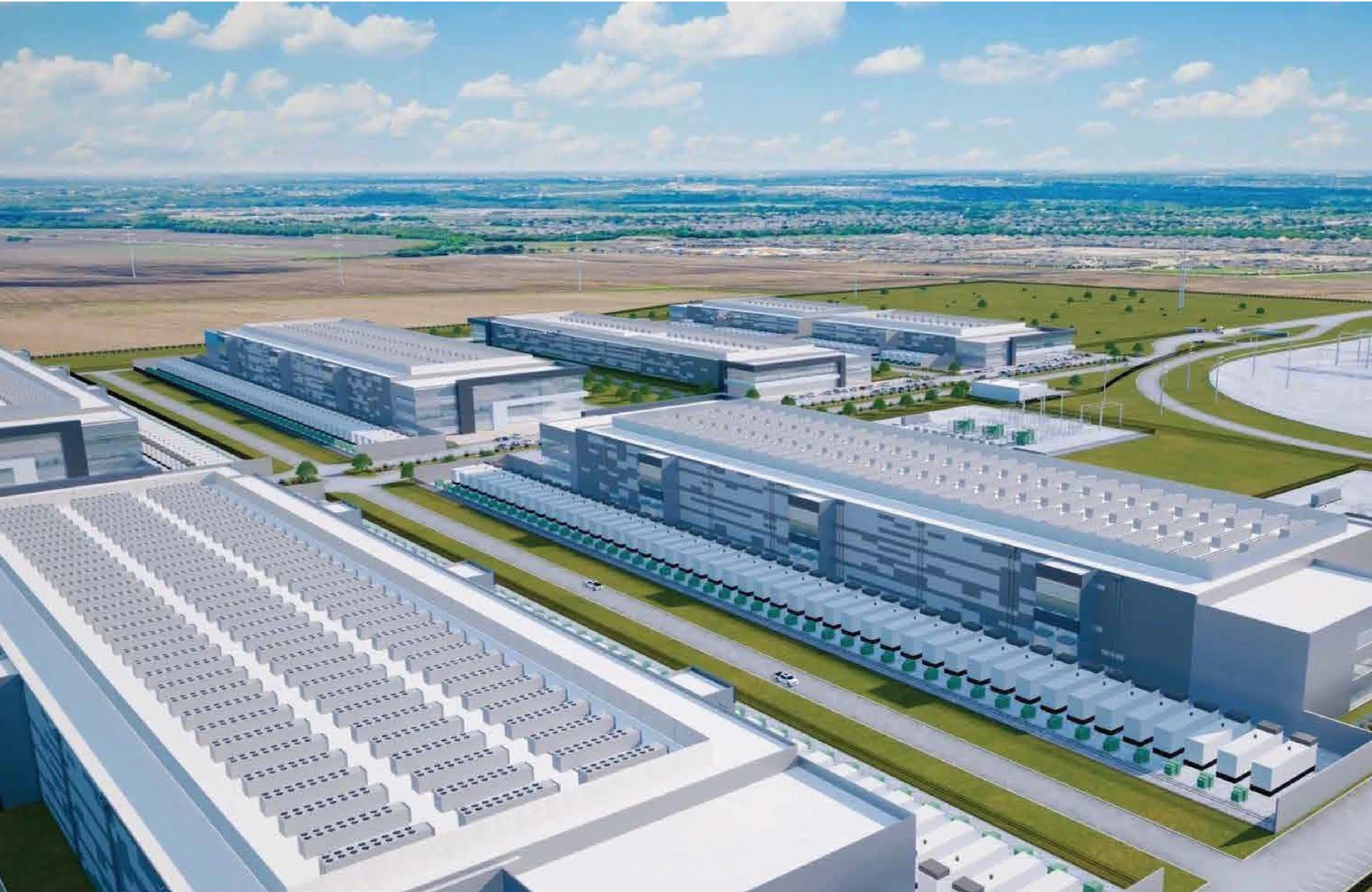 Aerial view of a large modern industrial complex with multiple large white buildings and a parking lot, surrounded by open fields and a distant horizon with scattered clouds in the sky.