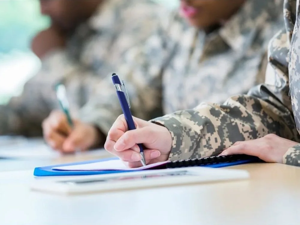 veterans writing at desk